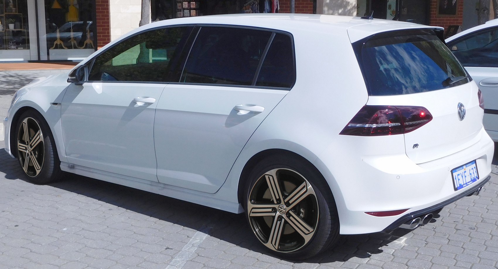White 5-door hatchback with tinted windows and distinctive alloy wheels