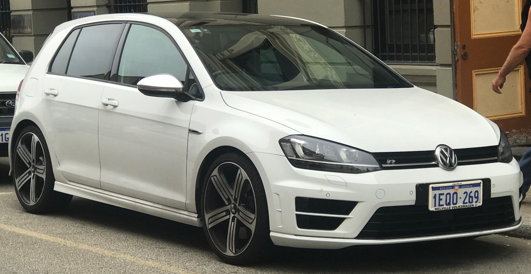 White 5-door hatchback showing front side with alloy wheels and headlights