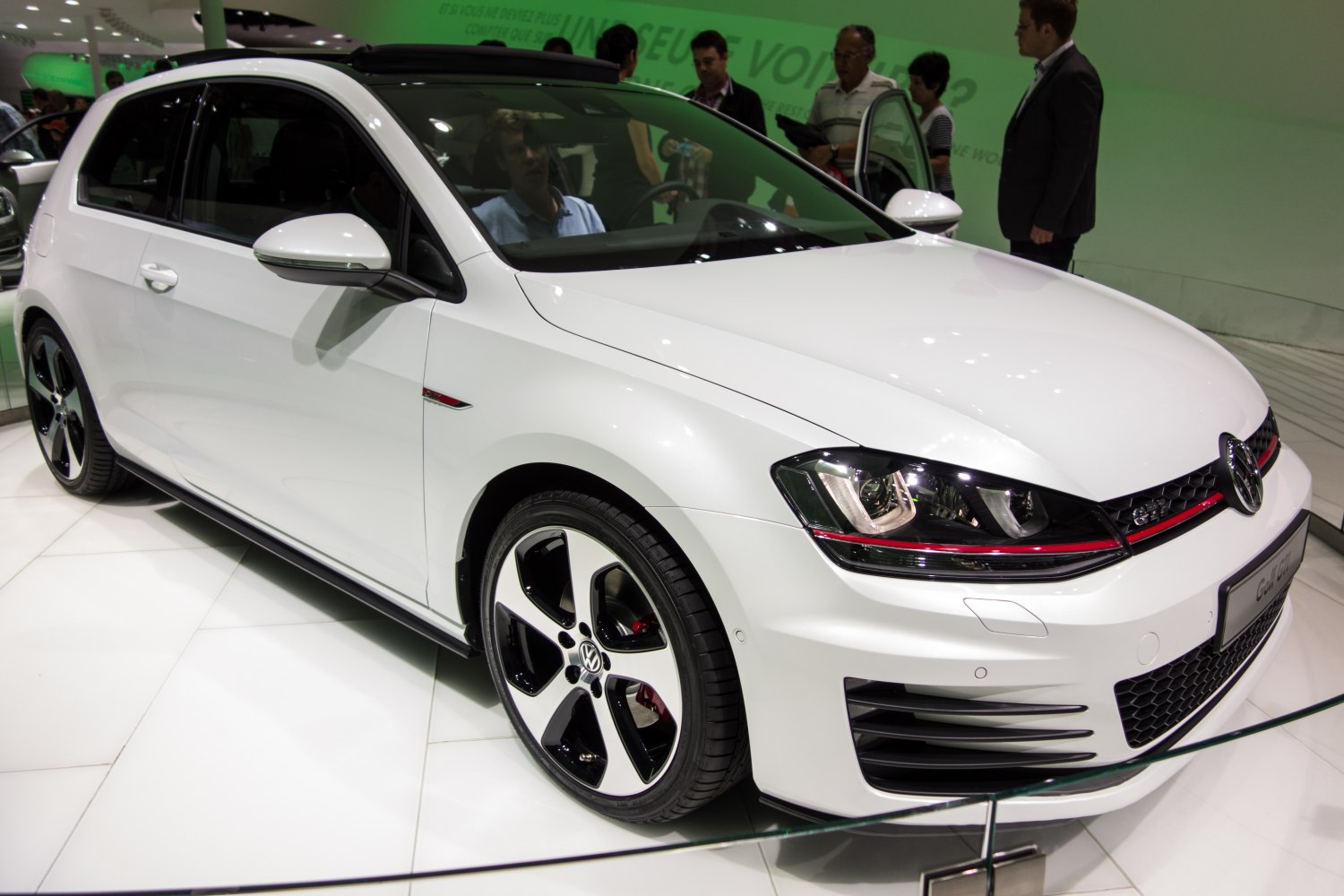 Sporty white compact hatchback with alloy wheels, aerodynamic design.