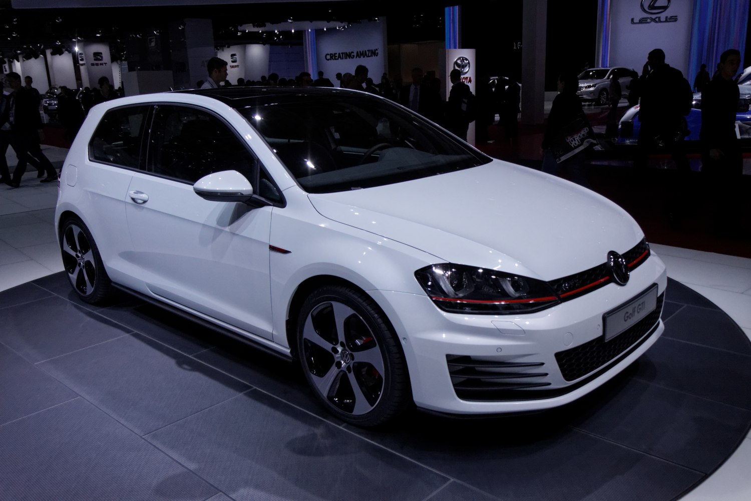 White 3-door hatchback with sporty alloy wheels and distinctive headlights
