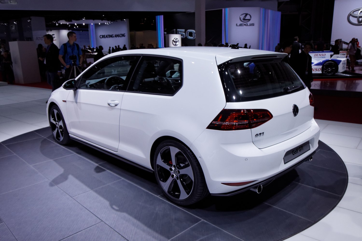 Rear and side view of 3-door hatchback with sporty taillights and dual exhaust