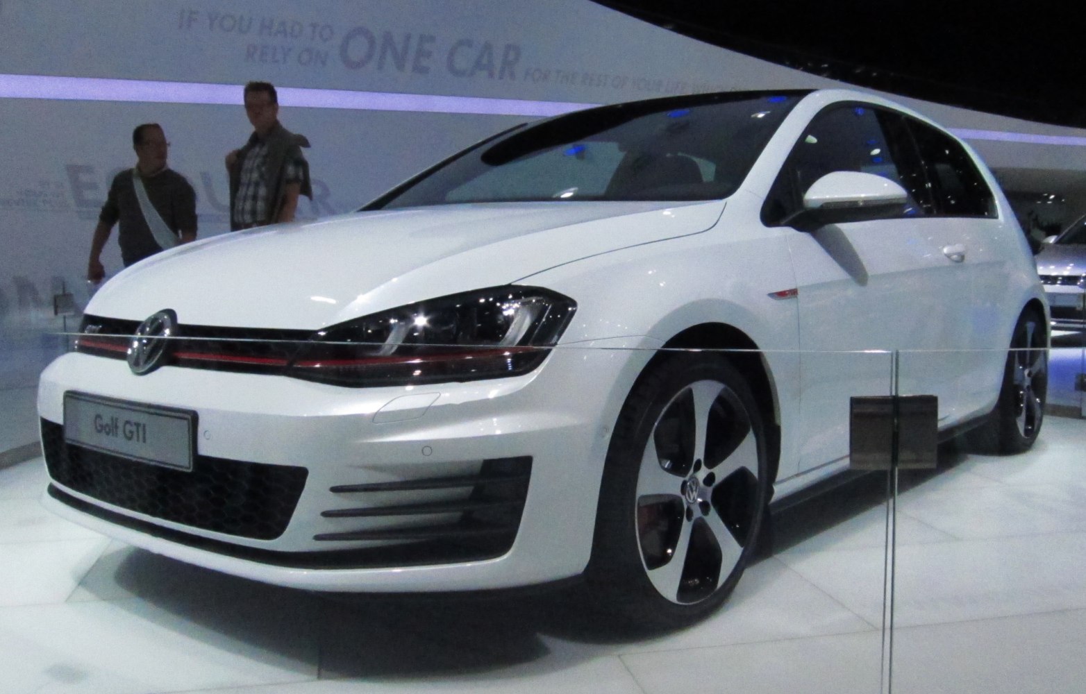 Front-side view of white 3-door hatchback with sporty wheels and sleek headlights