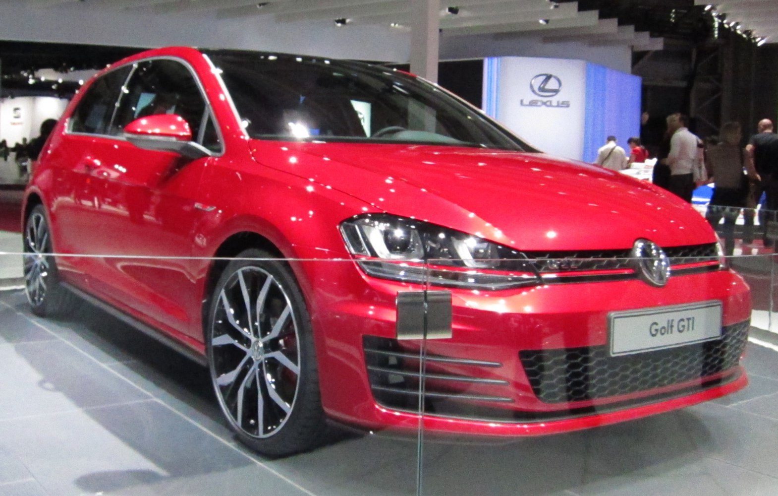 Red 3-door hatchback front profile with black alloy wheels