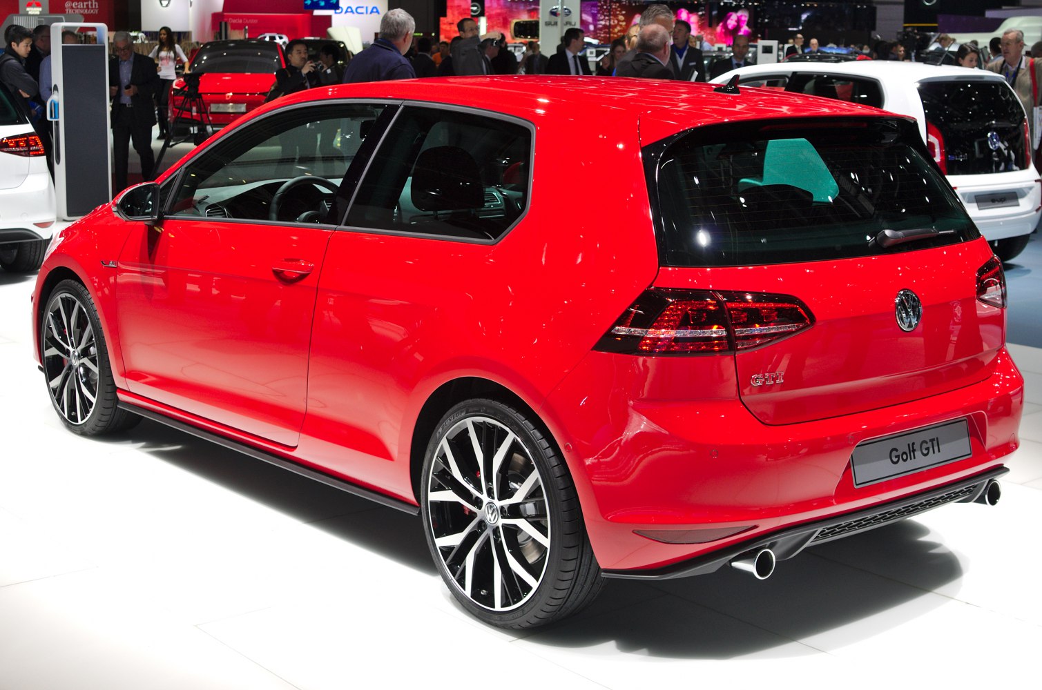Red 3-door hatchback rear side with sporty wheels and dual exhaust