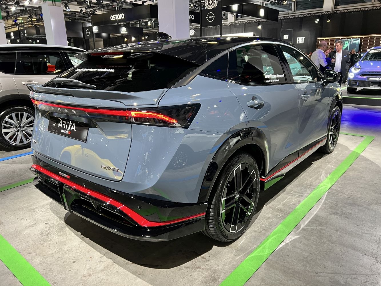 Rear side view of Nissan Ariya with NISMO styling, sleek taillights, and sport rims
