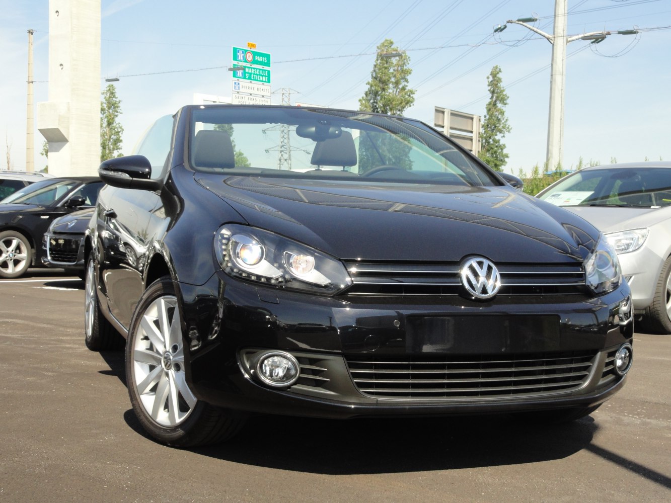 Front view of black convertible with LED headlights and sleek grille
