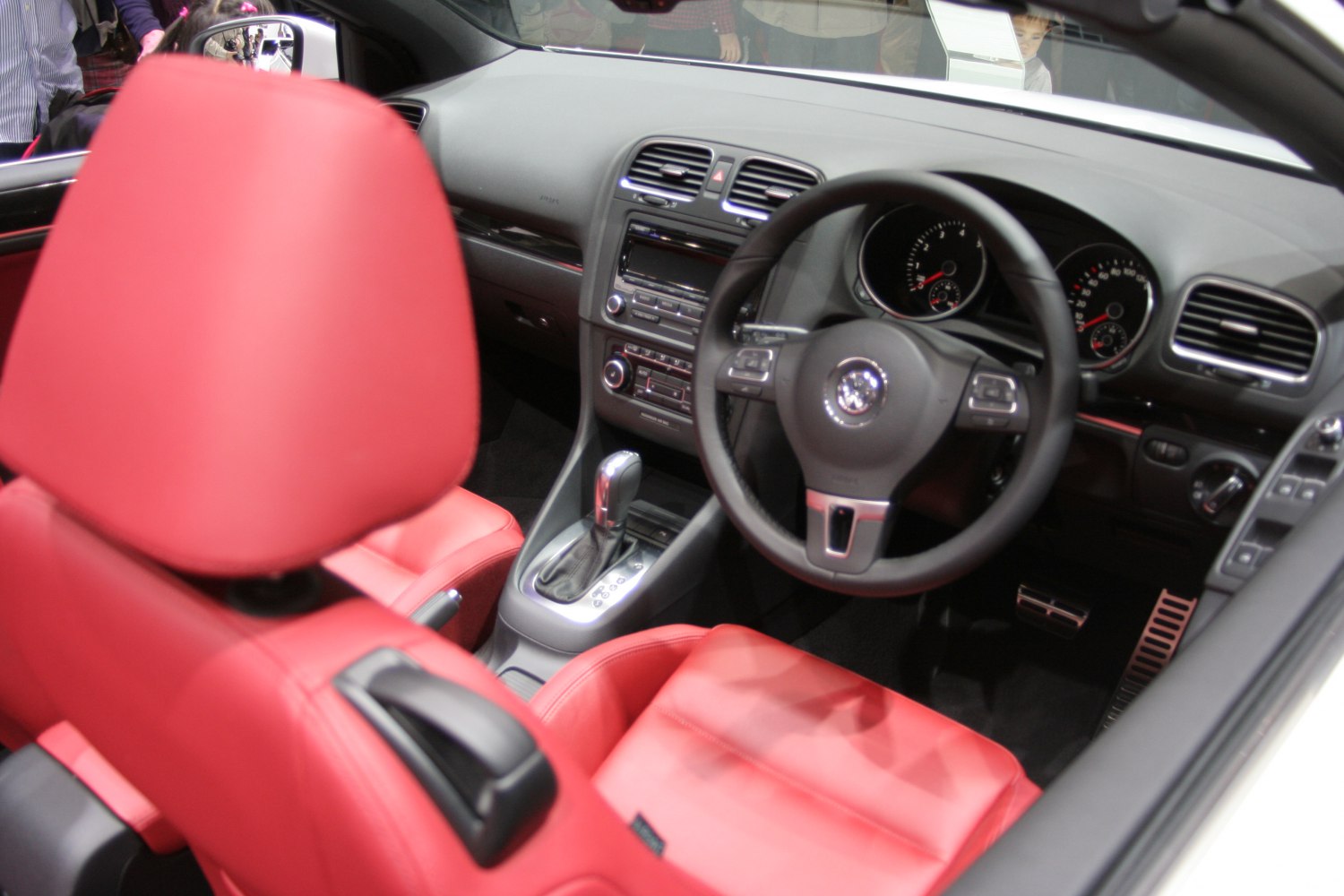Red leather seats and automatic transmission gear shift in car interior