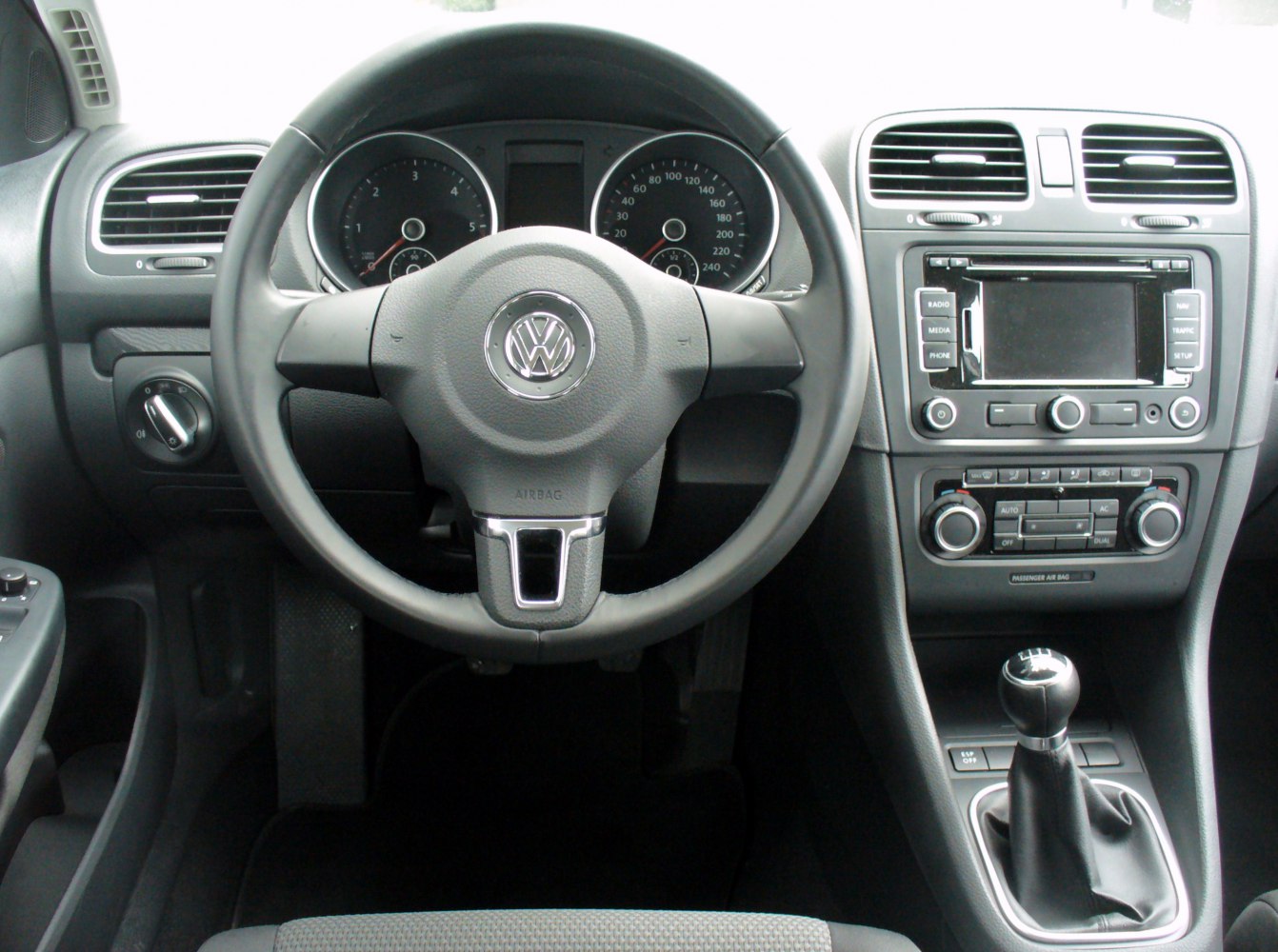 Steering wheel, dashboard with controls, manual gear shift