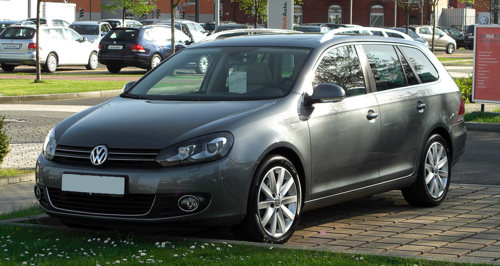 Silver station wagon front-side view with alloy wheels and roof rails