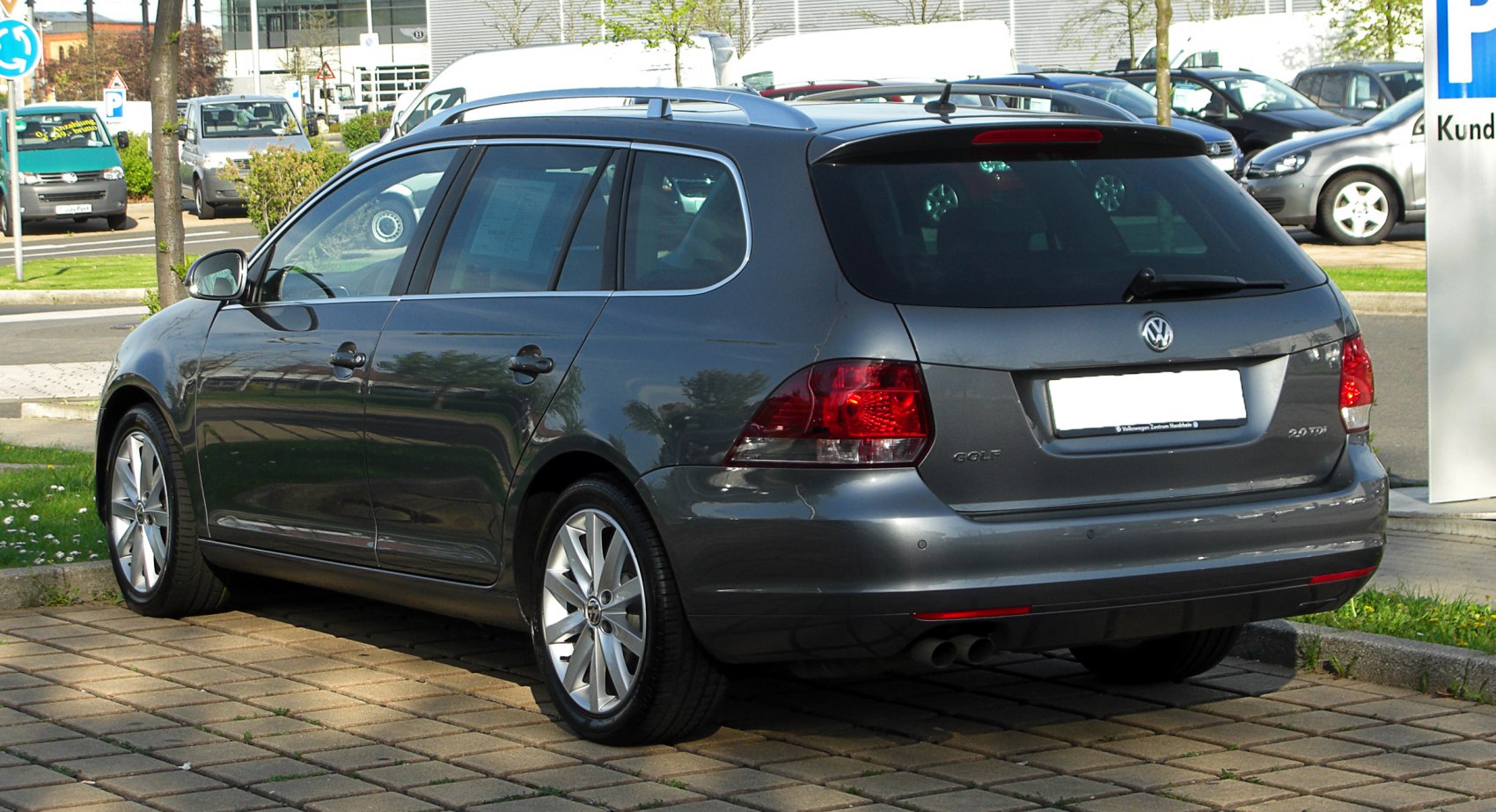 Rear view with taillights, alloy wheels, roof rails of compact wagon
