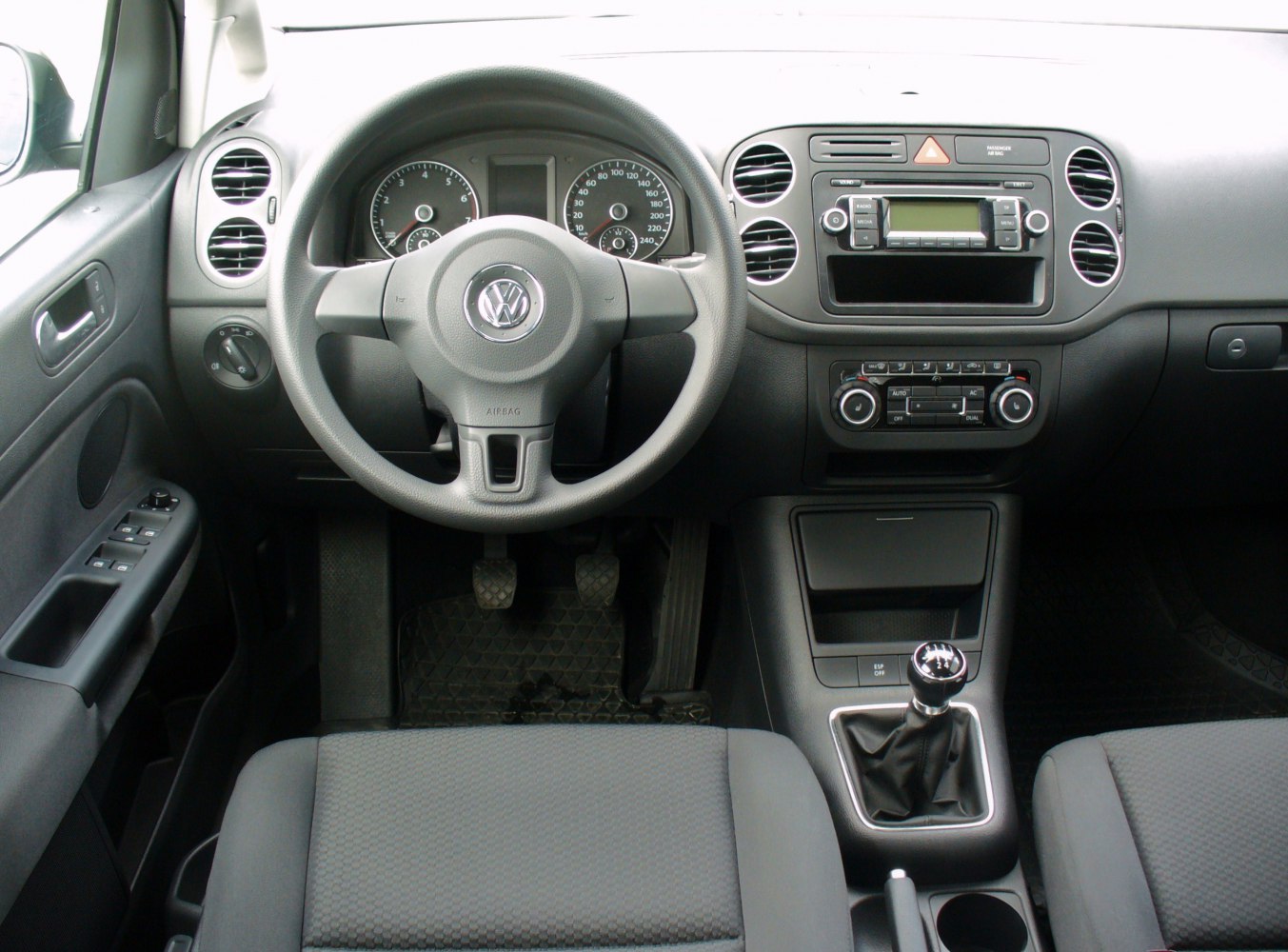 Dashboard and manual gear shift interior with steering wheel and control panels