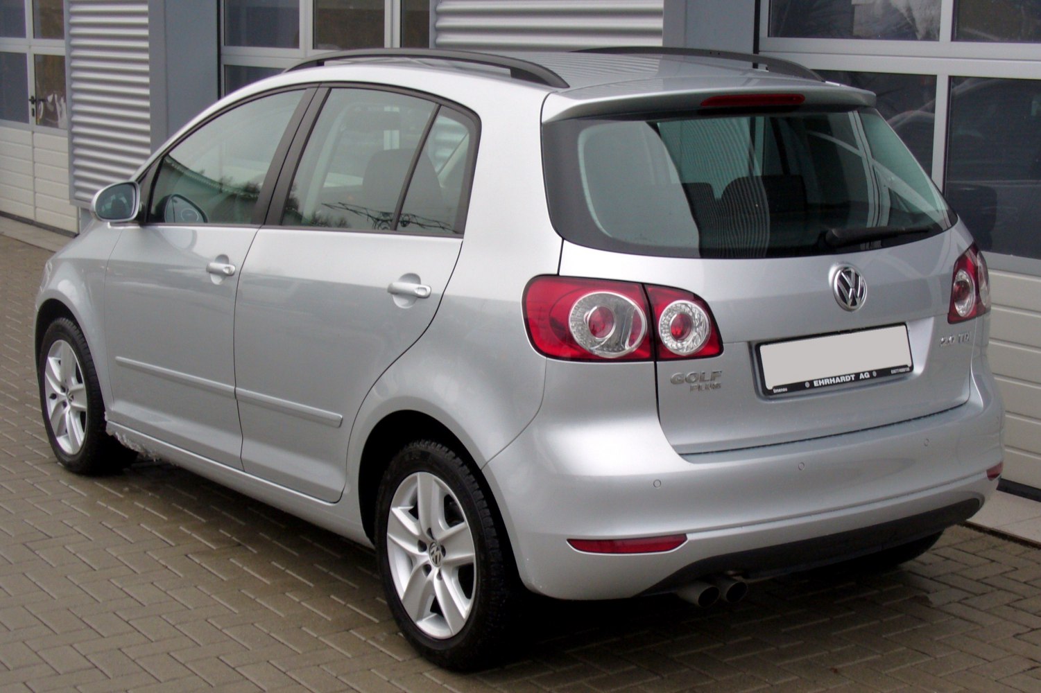 Silver hatchback rear view with distinctive taillights and roof rails