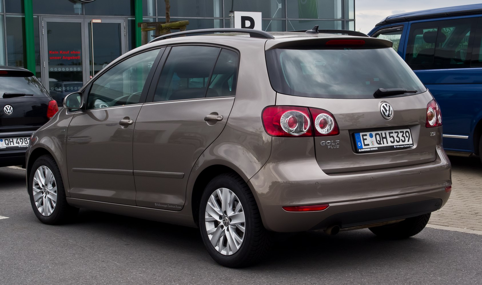 Rear side view of a hatchback with distinctive tail lights and roof rails