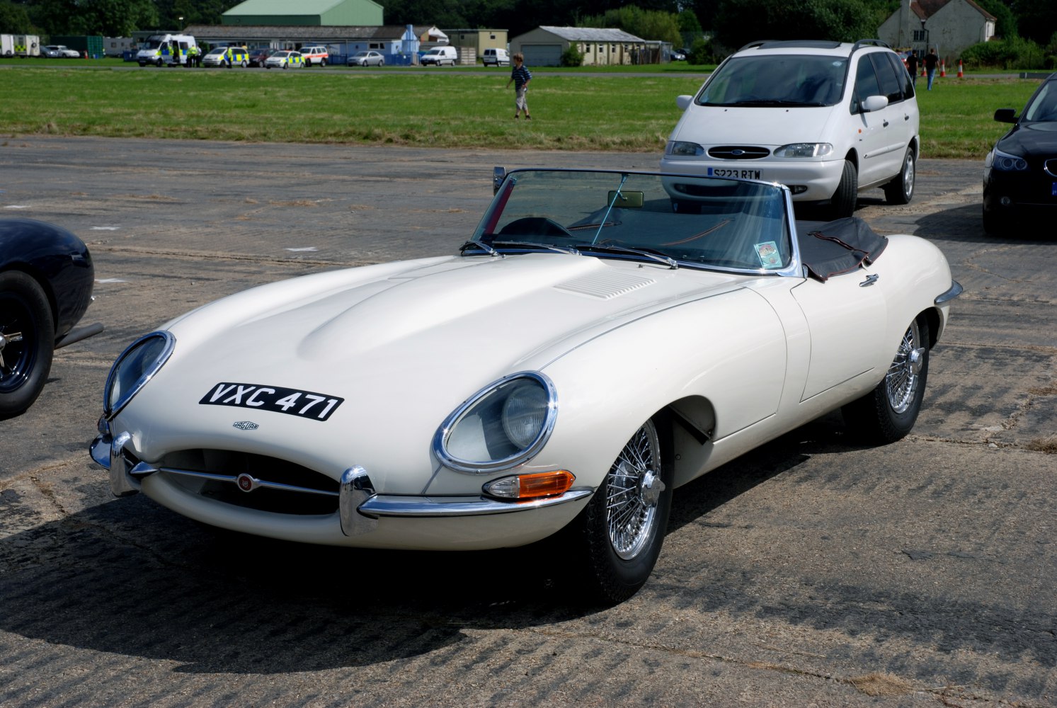 Long bonnet and wire-spoke wheels of a convertible sports car