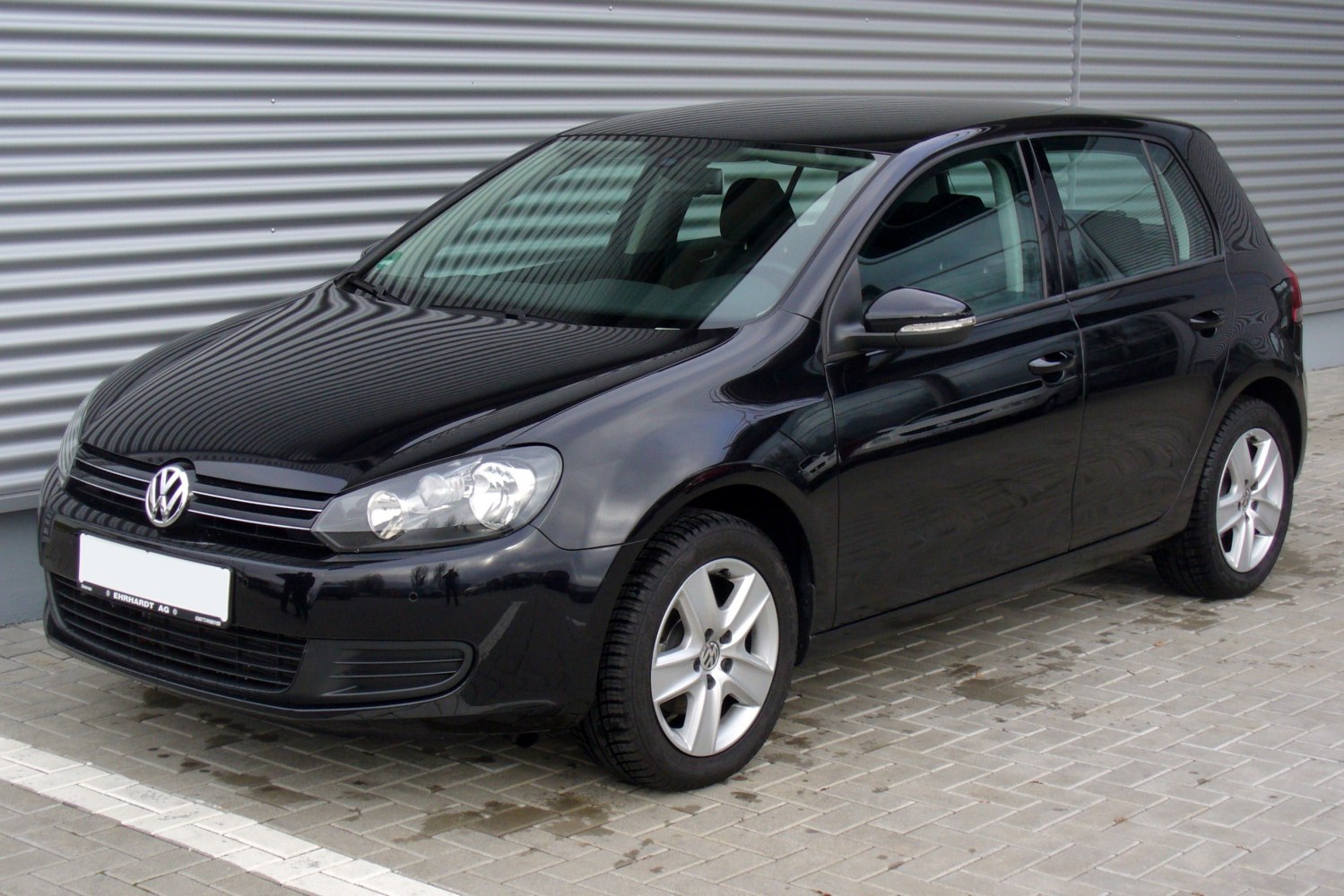 Front side view of black 5-door hatchback with distinctive headlights and alloy wheels