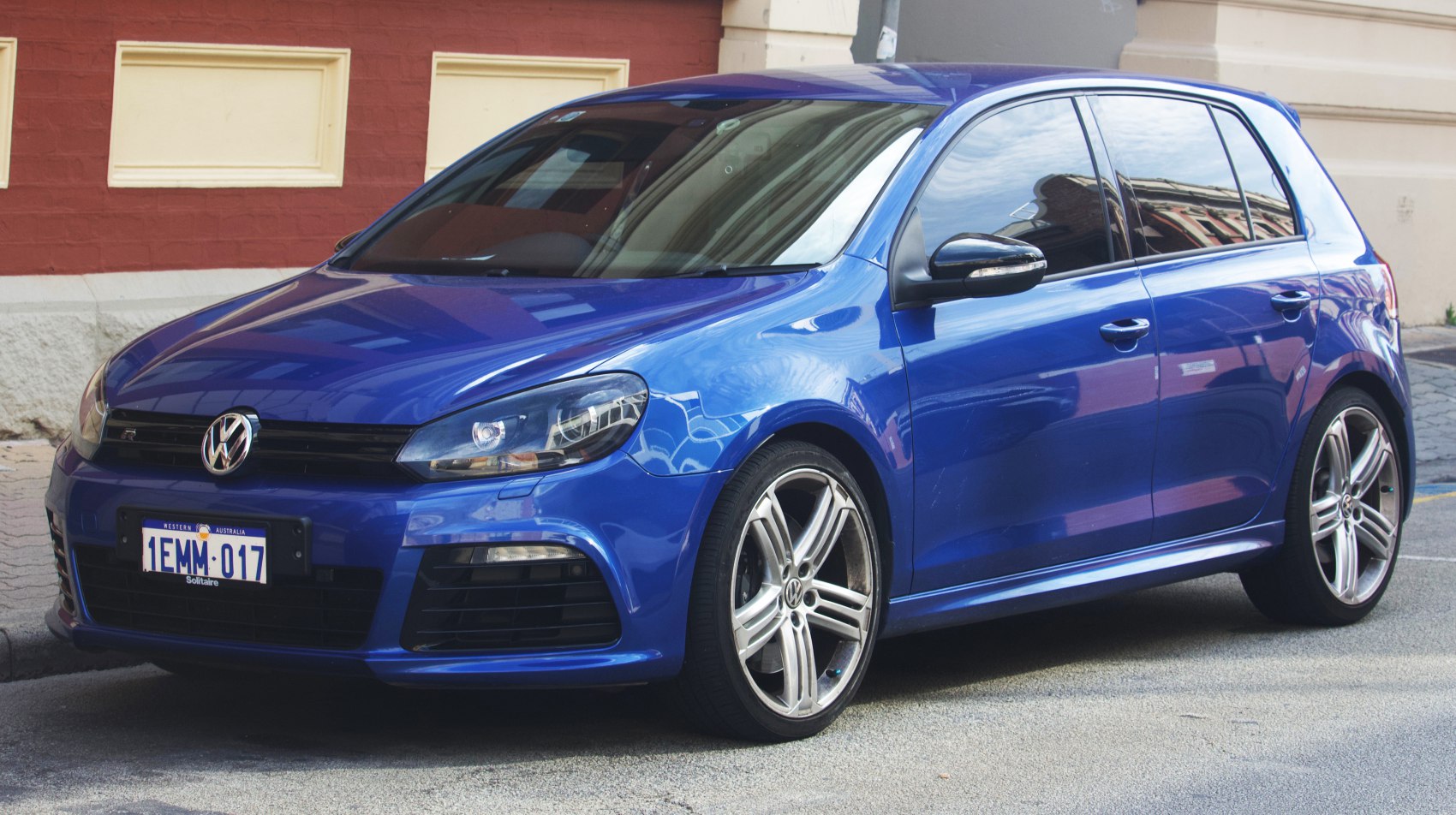 Blue 5-door hatchback with alloy wheels and tinted windows.