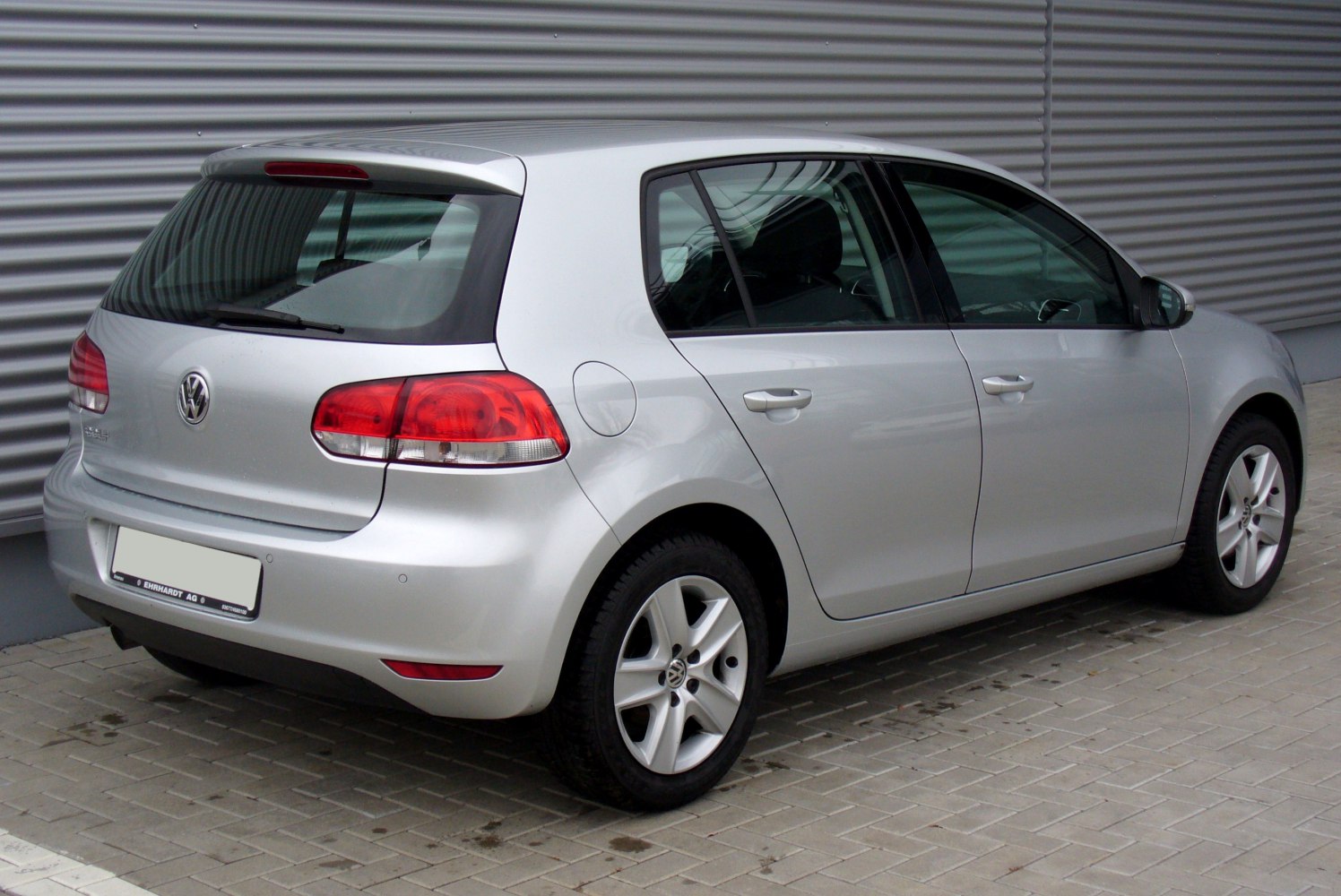 Rear view of a silver 5-door hatchback with spoiler and alloy wheels