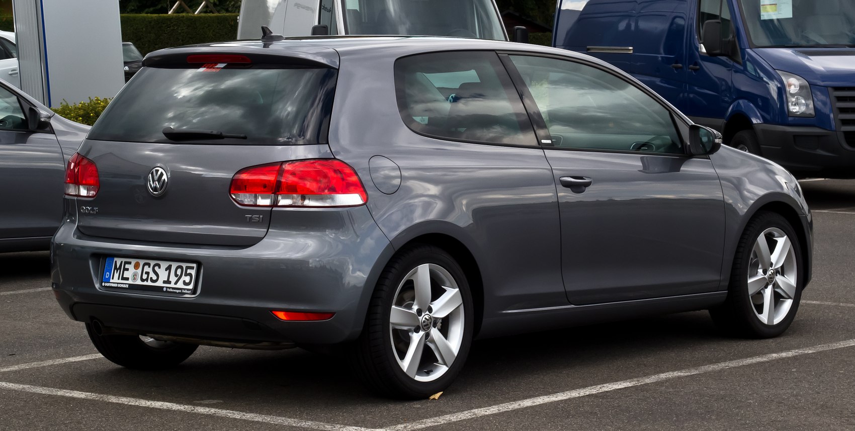 Rear side view of a compact 3-door hatchback with alloy wheels and taillights