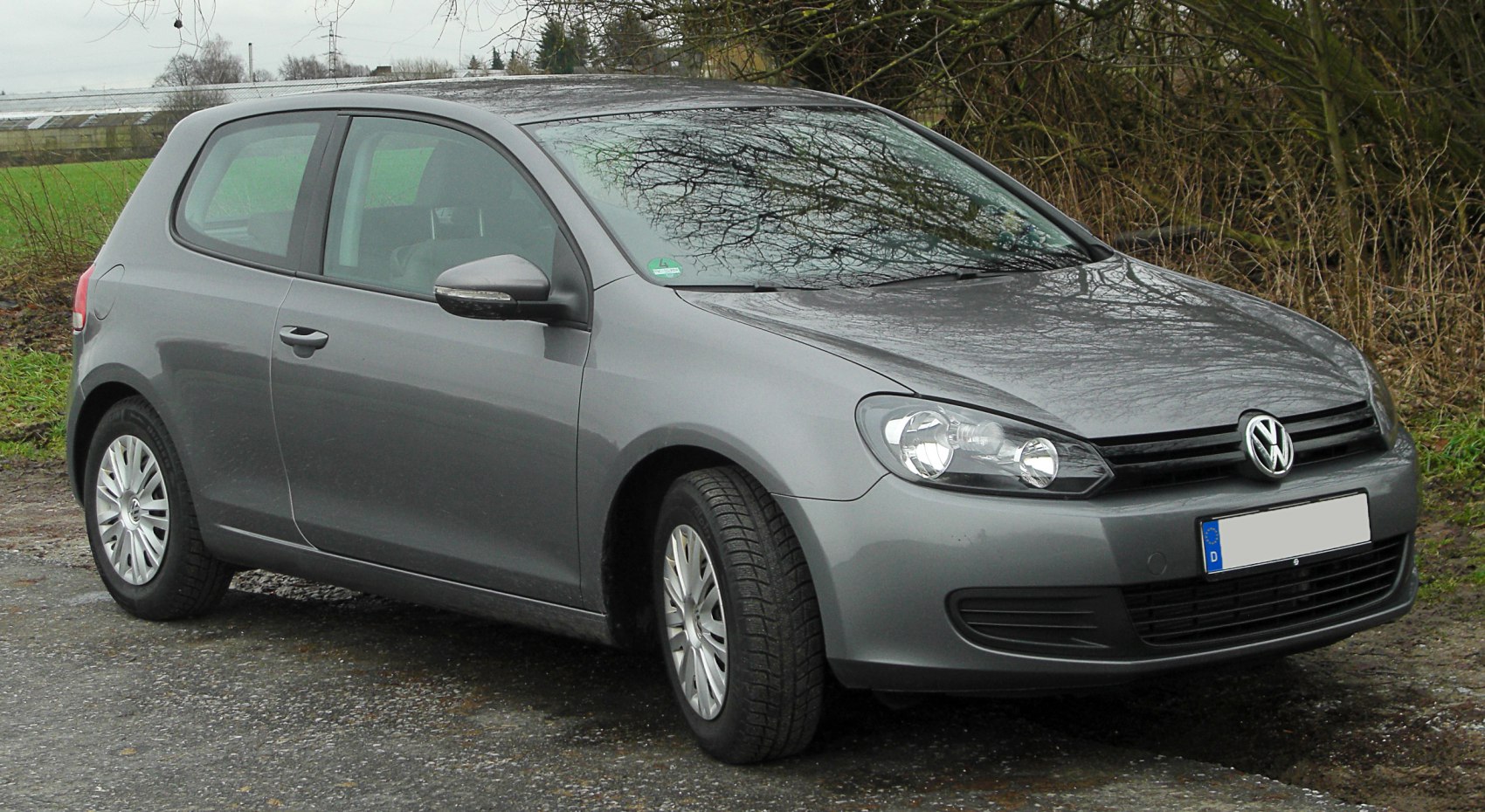 Front side view of a 3-door hatchback with sleek headlights and alloy wheels