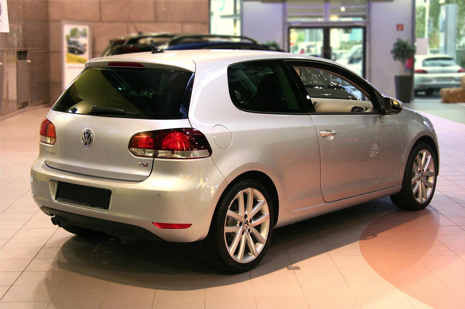 Silver 3-door hatchback rear-side view with alloy wheels and tinted windows