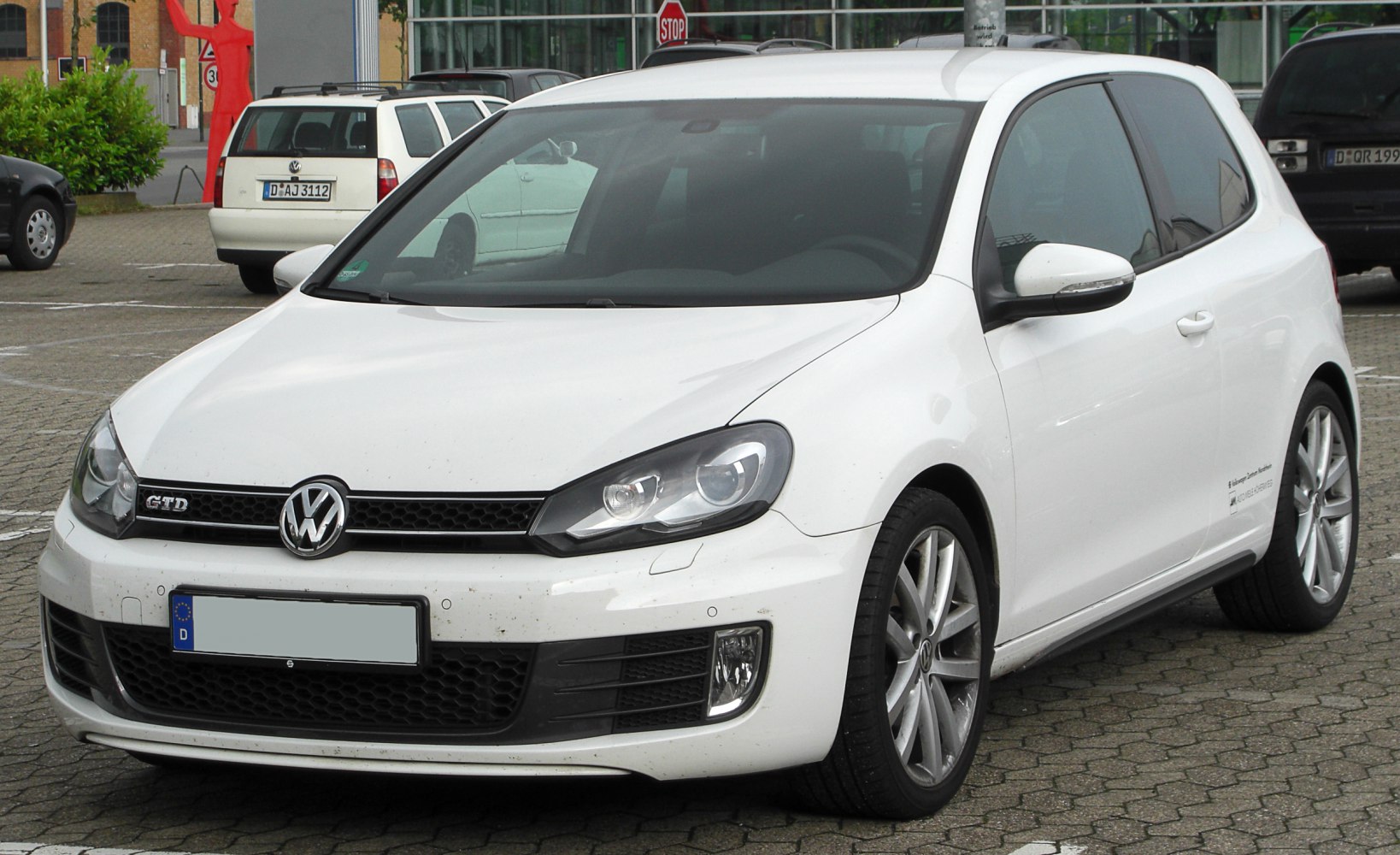 White 3-door hatchback with modern headlights and alloy wheels