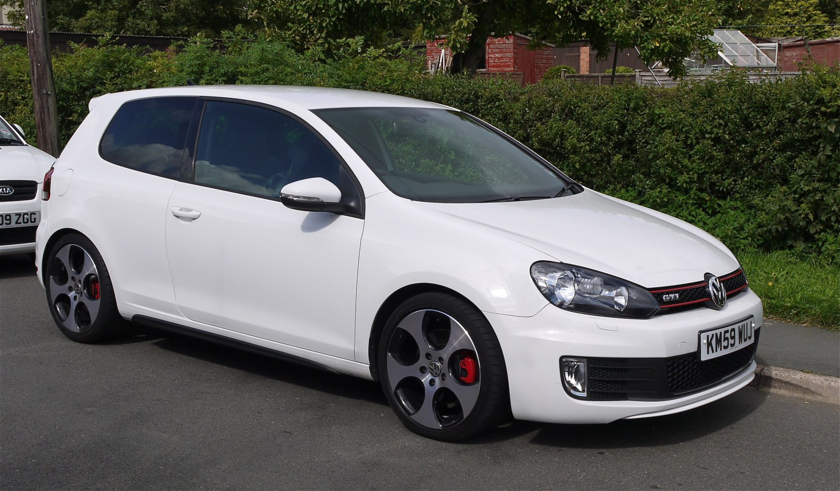White 3-door hatchback with sporty alloy wheels and front grille