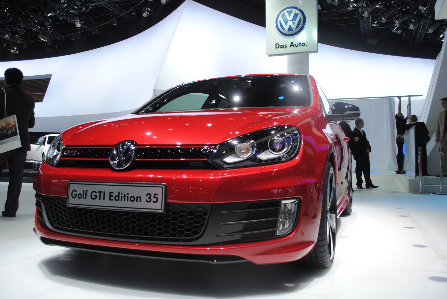 Front view of a red hatchback with LED headlights and honeycomb grille.