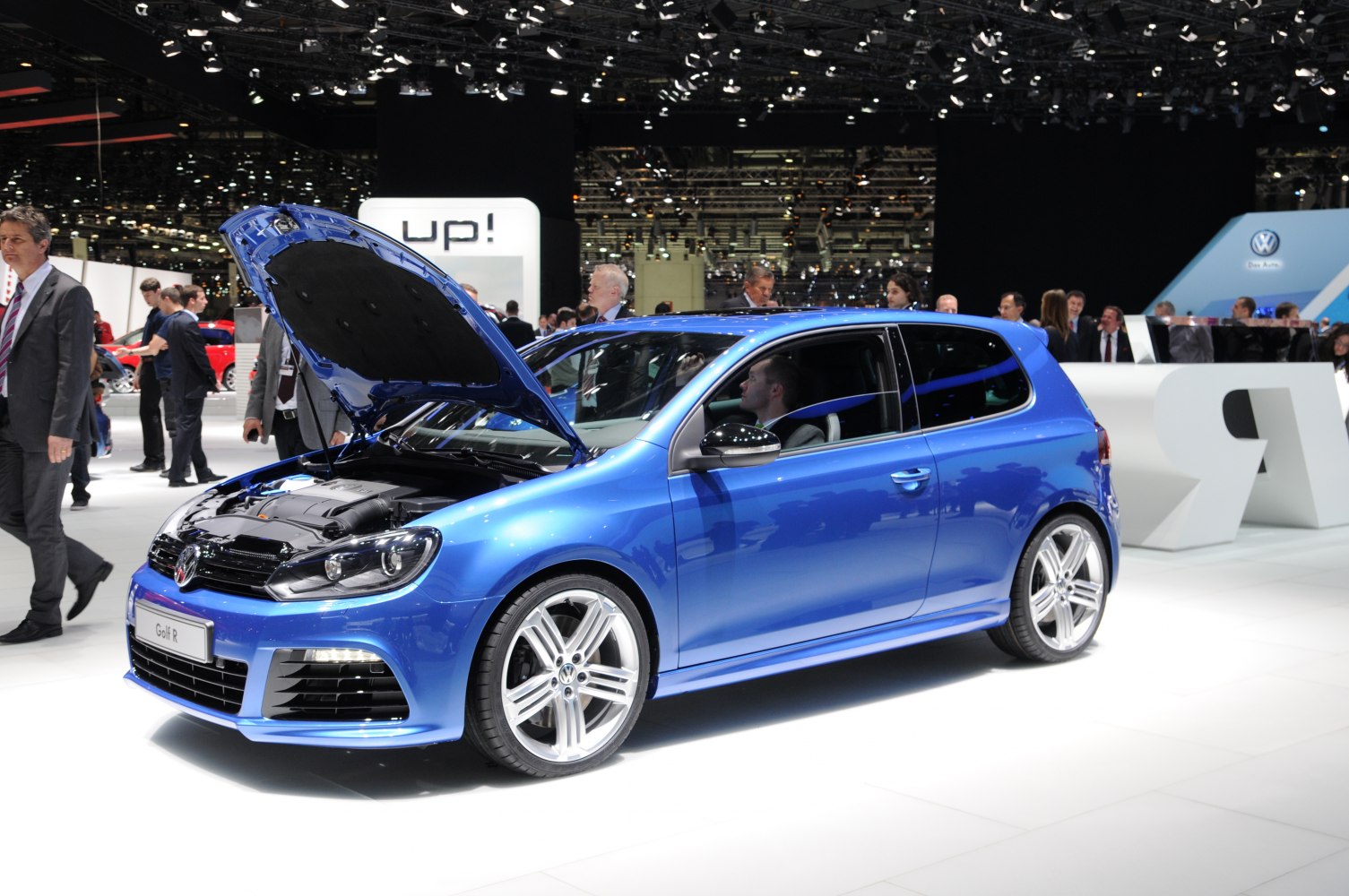 Blue 3-door hatchback with open hood showing engine