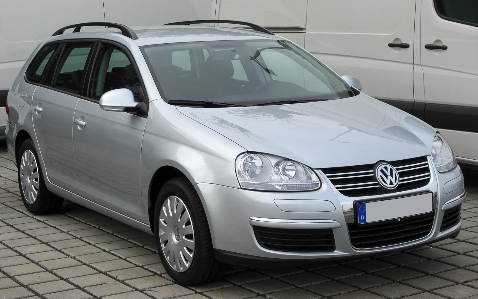 Silver station wagon front view with distinct headlights and roof rails