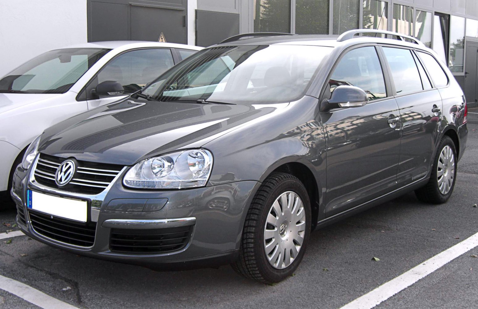 Grey station wagon with front side view and roof rails