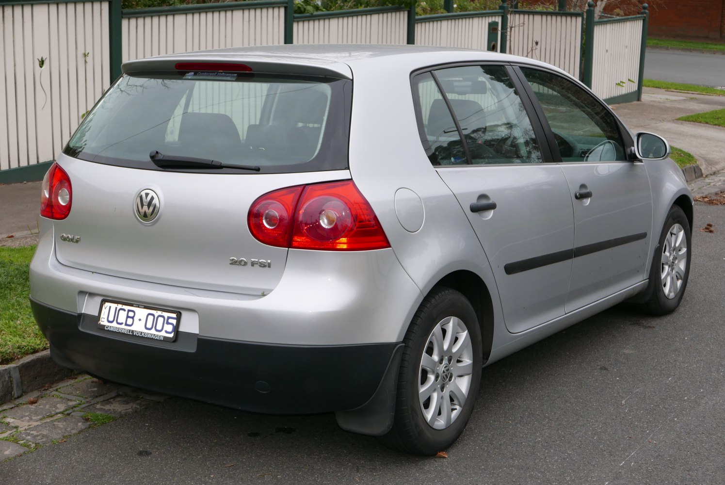 Rear view of a 5-door hatchback with 2.0 FSI badge and red tail lights
