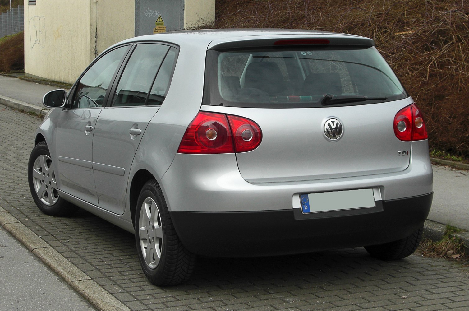 Silver 5-door hatchback rear with rounded taillights and rear windshield wiper
