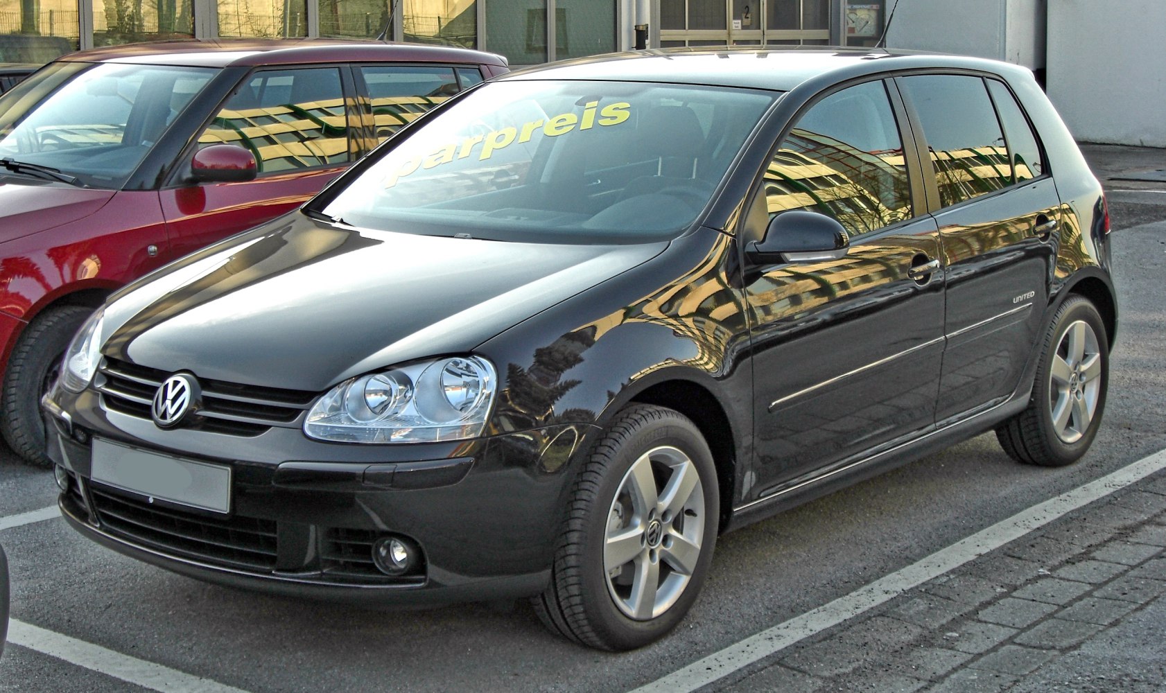 Black 5-door hatchback with clear headlamps and alloy wheels