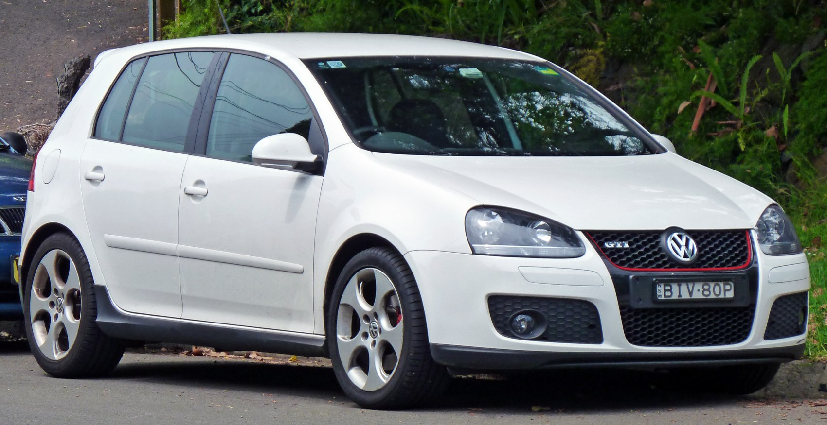 White 5-door hatchback with sporty grille and alloy wheels