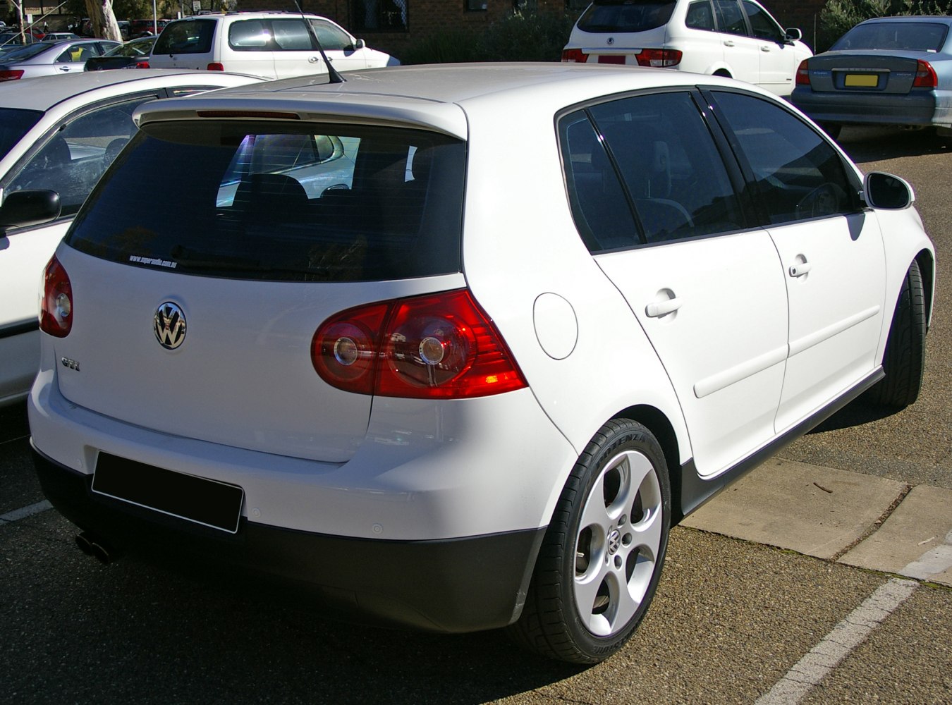 Rear view of a 5-door hatchback with distinctive taillights and alloy wheels.