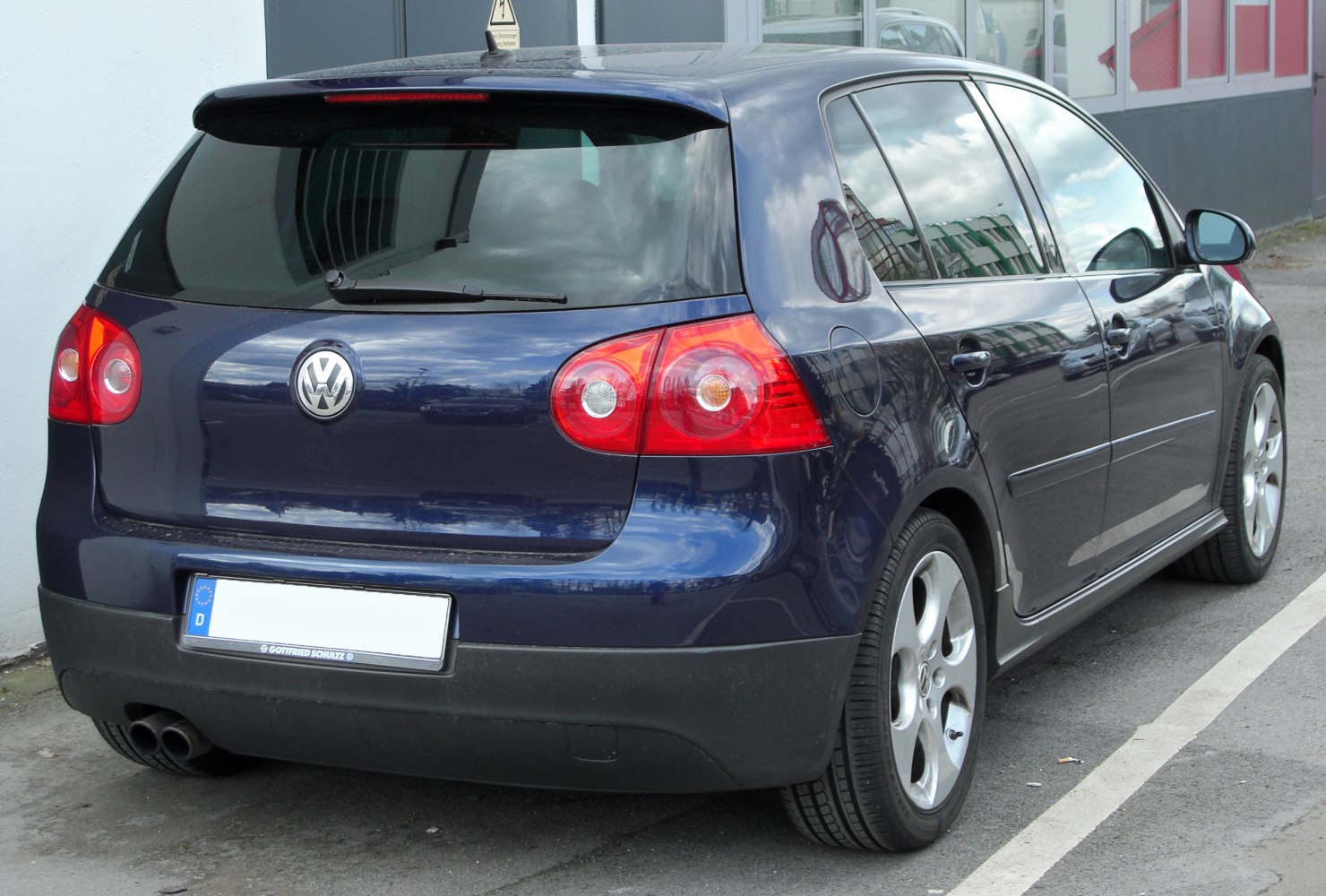 Rear hatchback view with distinct round taillights and dual exhaust tips