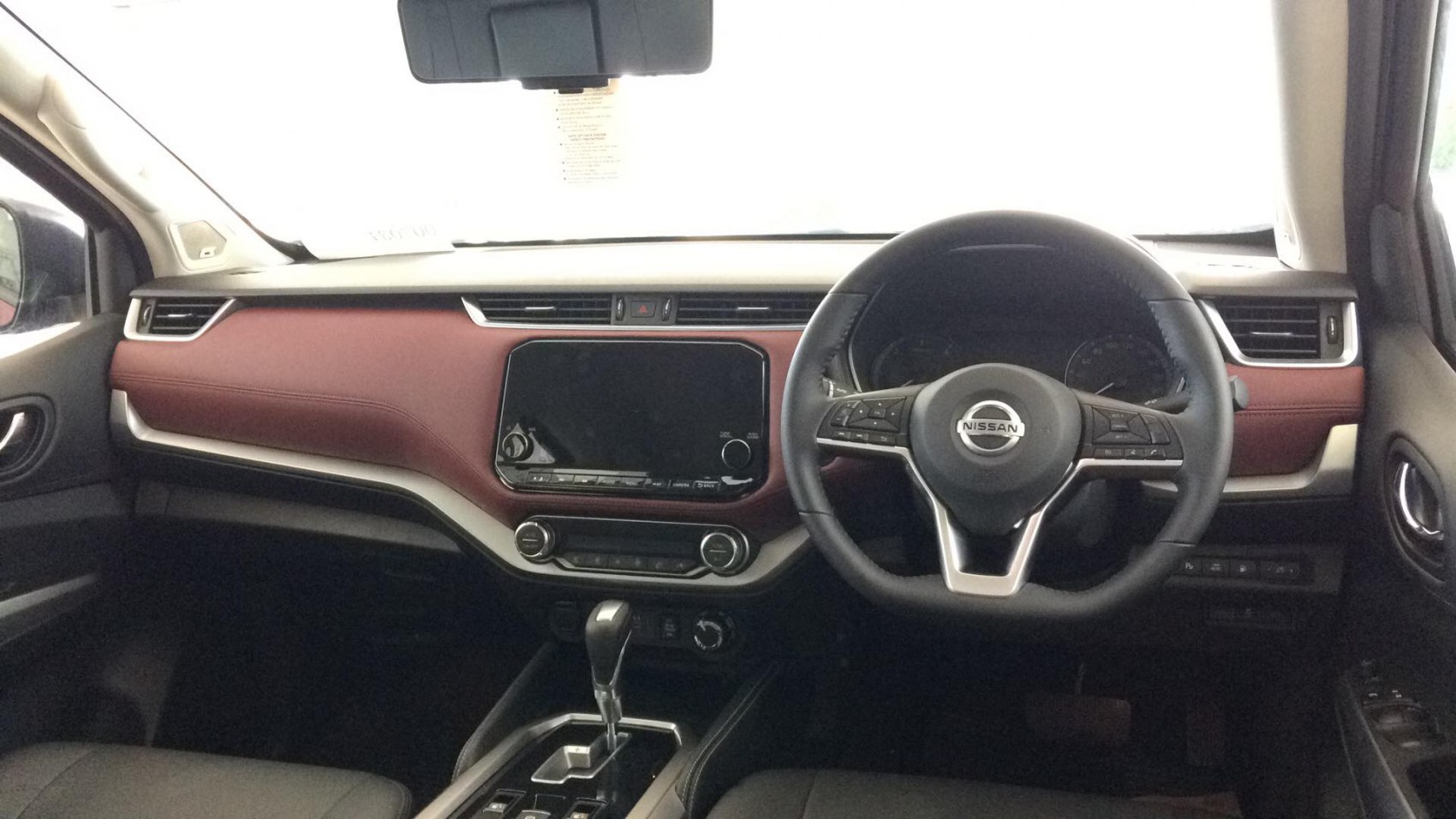 Modern vehicle interior dashboard with infotainment and steering wheel controls