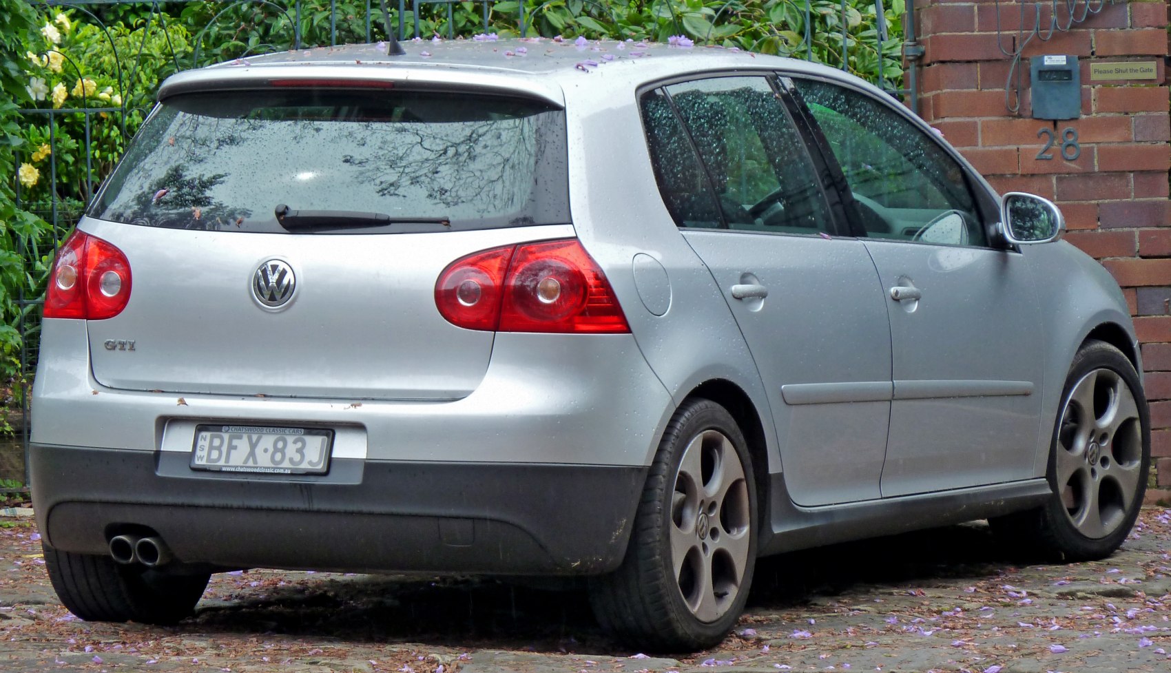 Rear and side view of a hatchback with dual exhaust and distinctive taillights