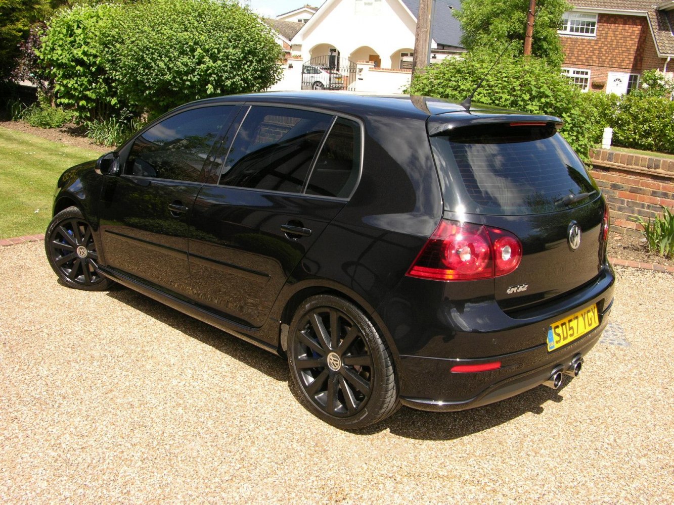 Black 5-door hatchback rear side with alloy wheels and dual exhaust
