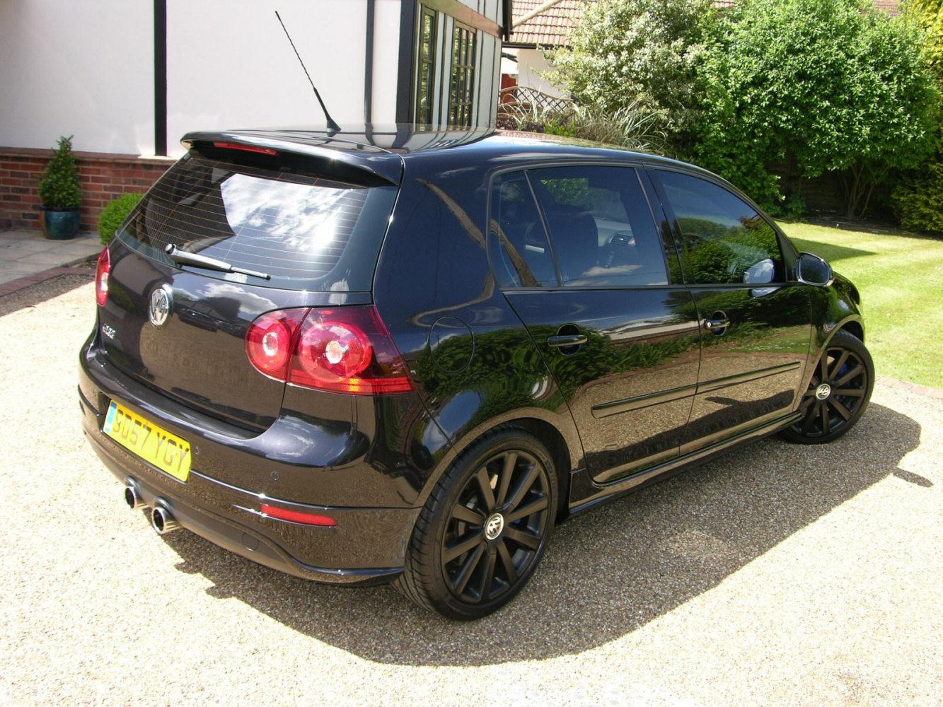 Black 5-door hatchback with dual exhaust and alloy wheels