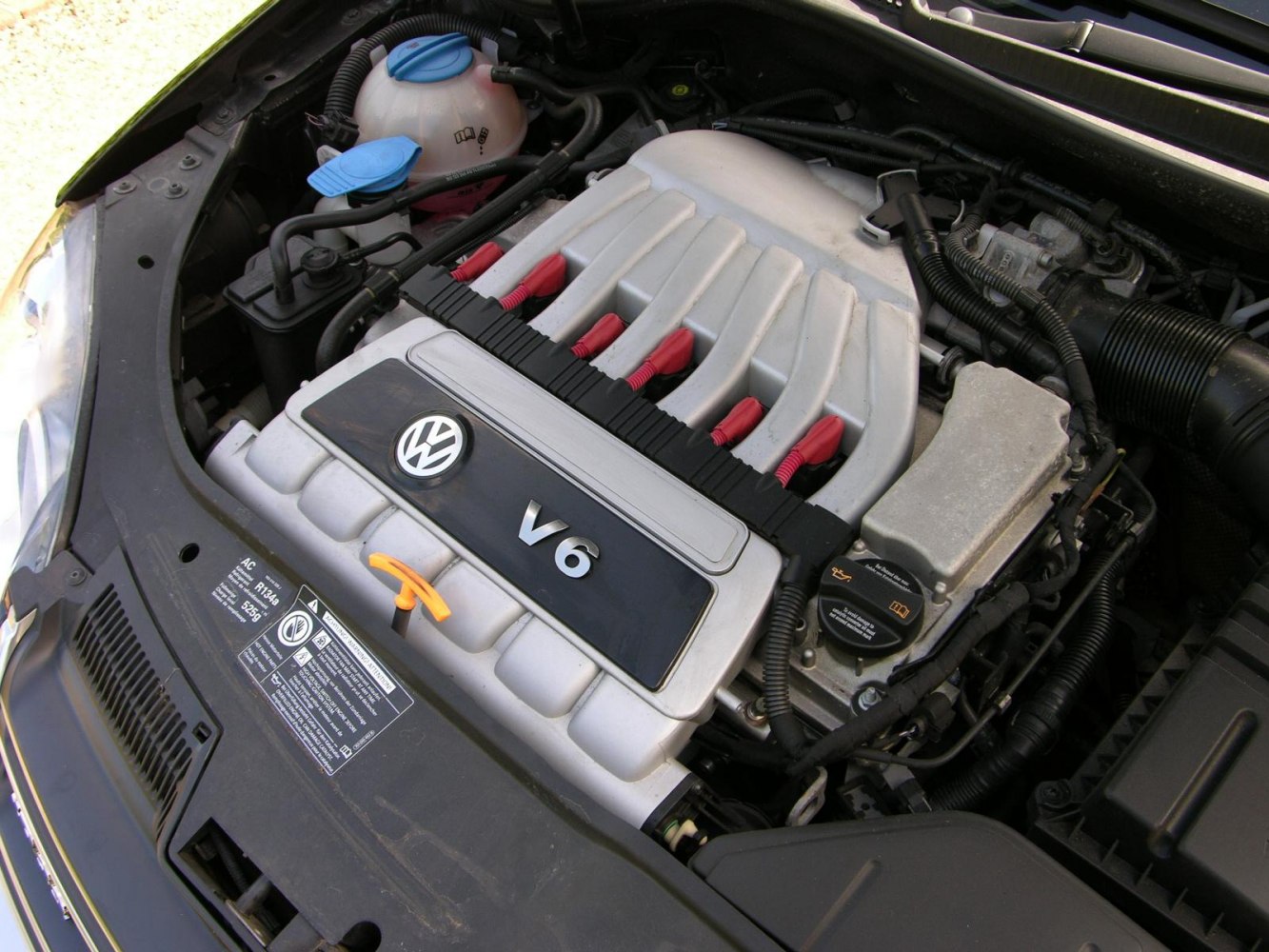 Close-up of V6 engine bay with Volkswagen badge and engine cover