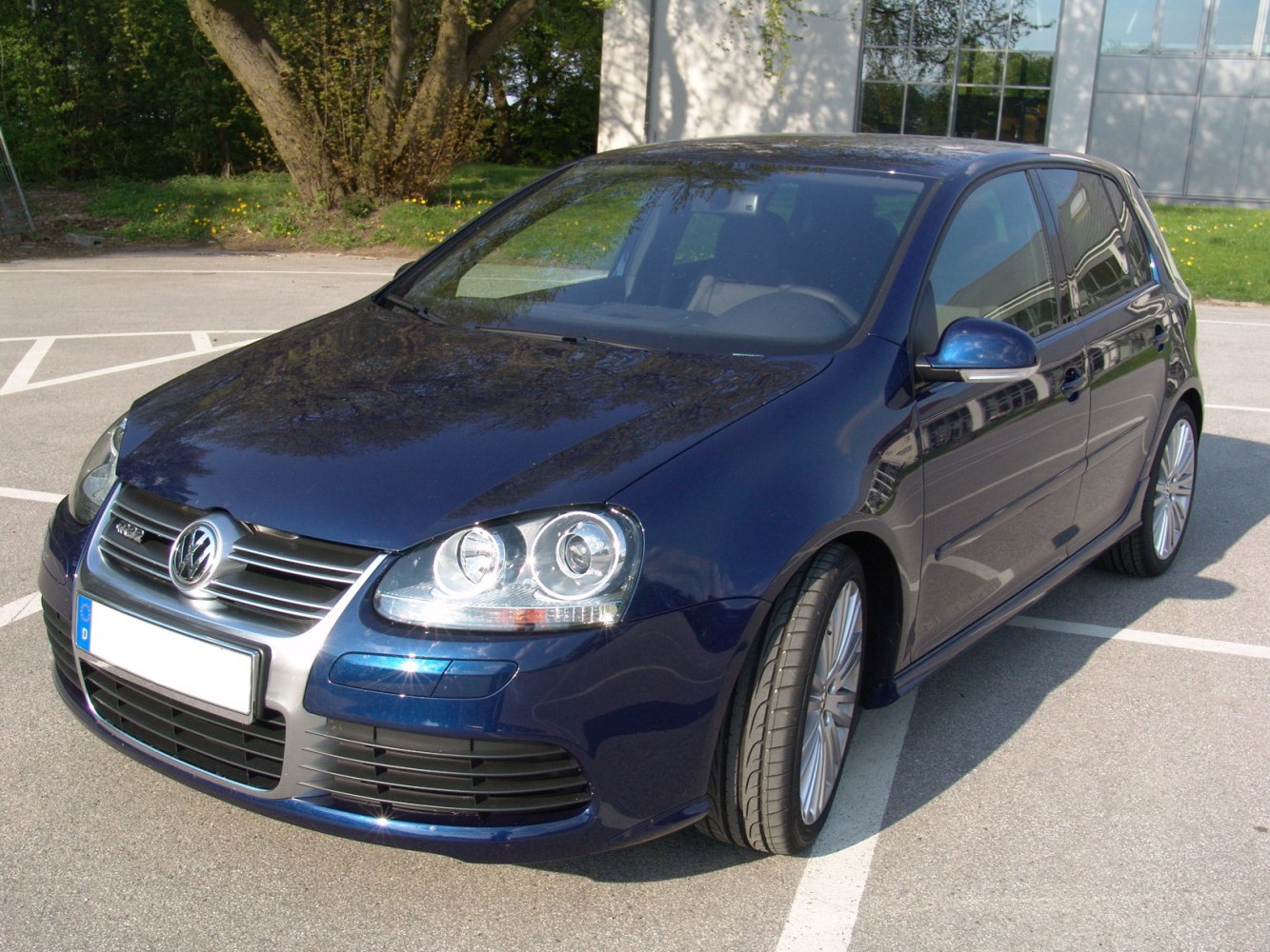 Front angled view with headlights, grille, and alloy wheels