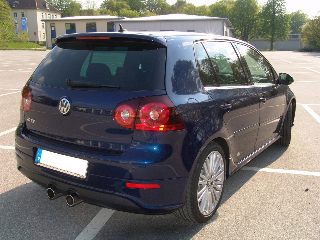 Rear view of a 5-door hatchback with dual exhaust and sporty taillights