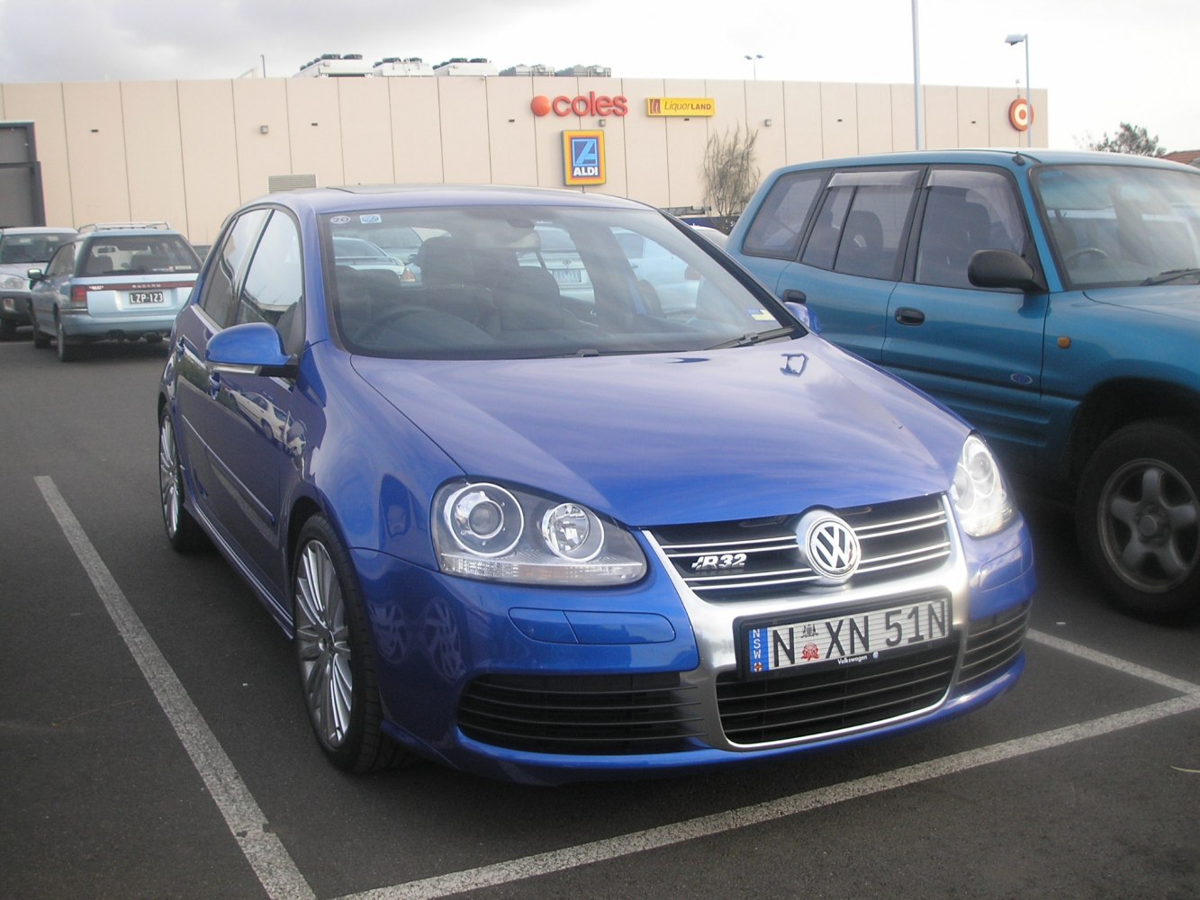 Blue 5-door hatchback with distinct headlights and grille