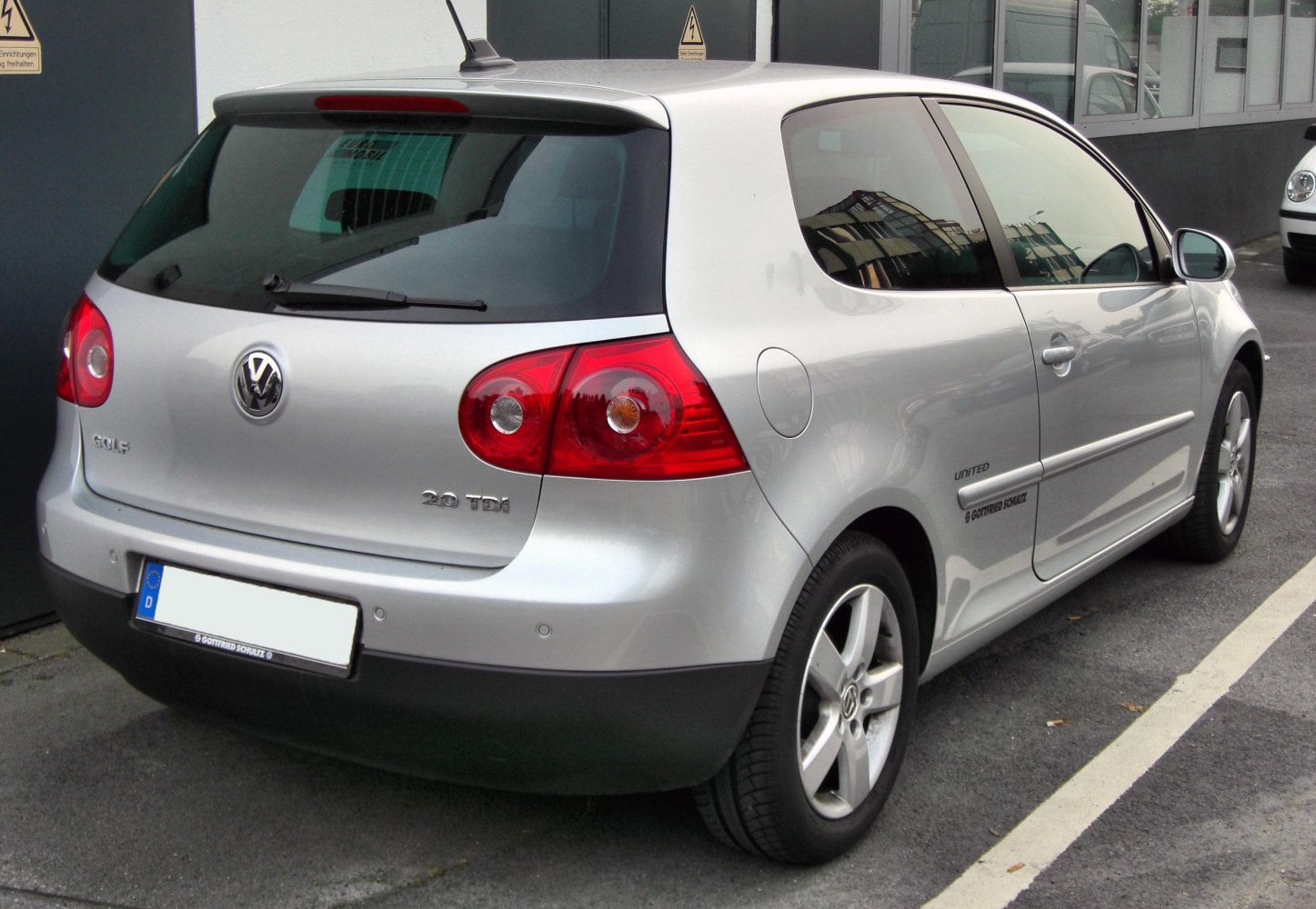 Rear and side view of a silver 3-door hatchback with distinctive tail lights and alloy wheels
