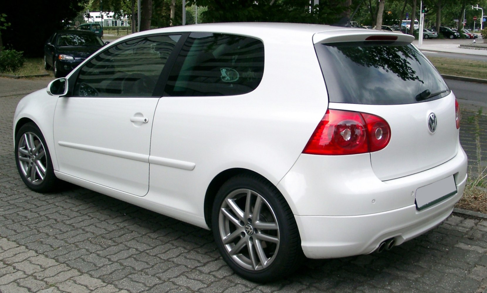 Rear and side view of a 3-door hatchback with spoiler and alloy wheels