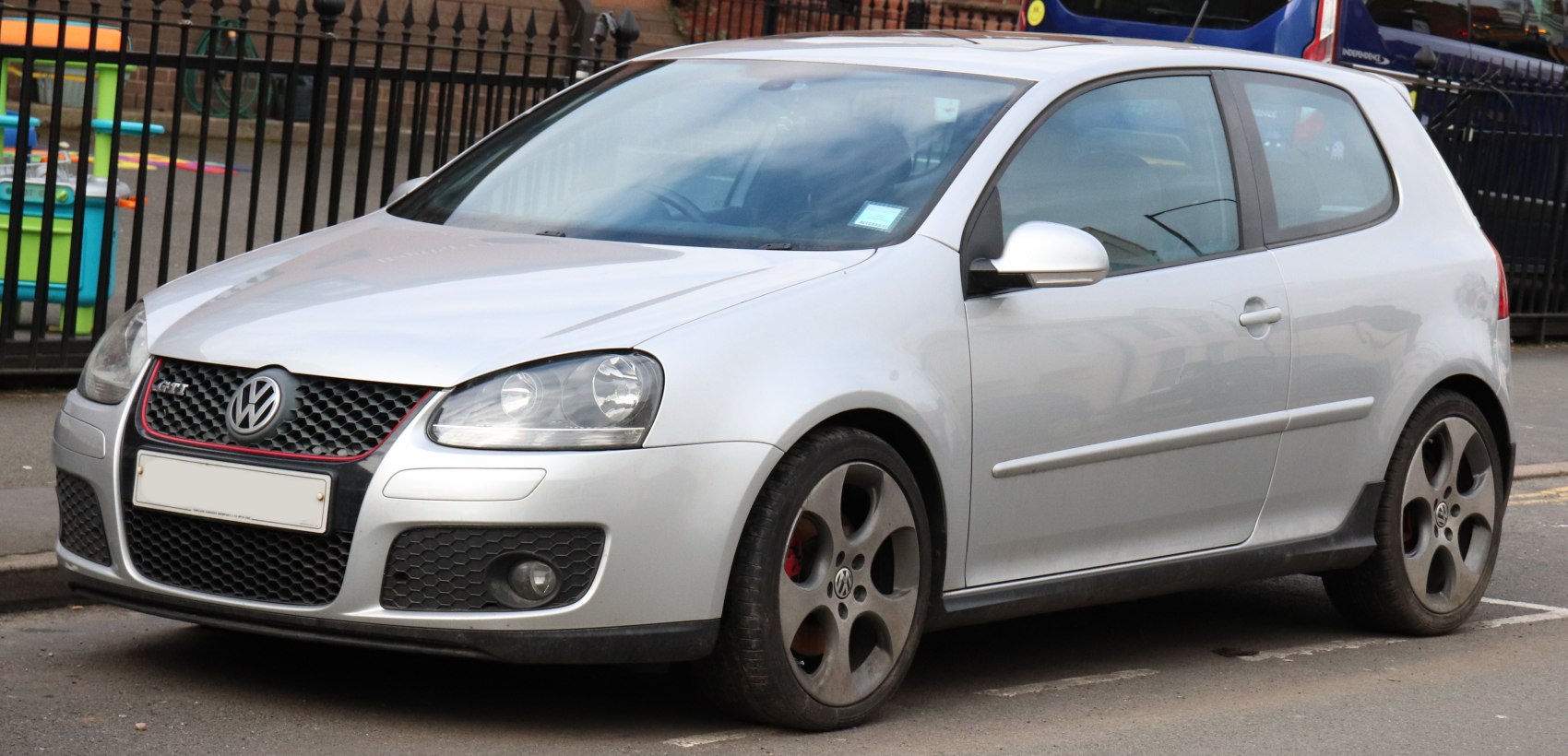 Silver car with honeycomb grille and five-spoke alloy wheels