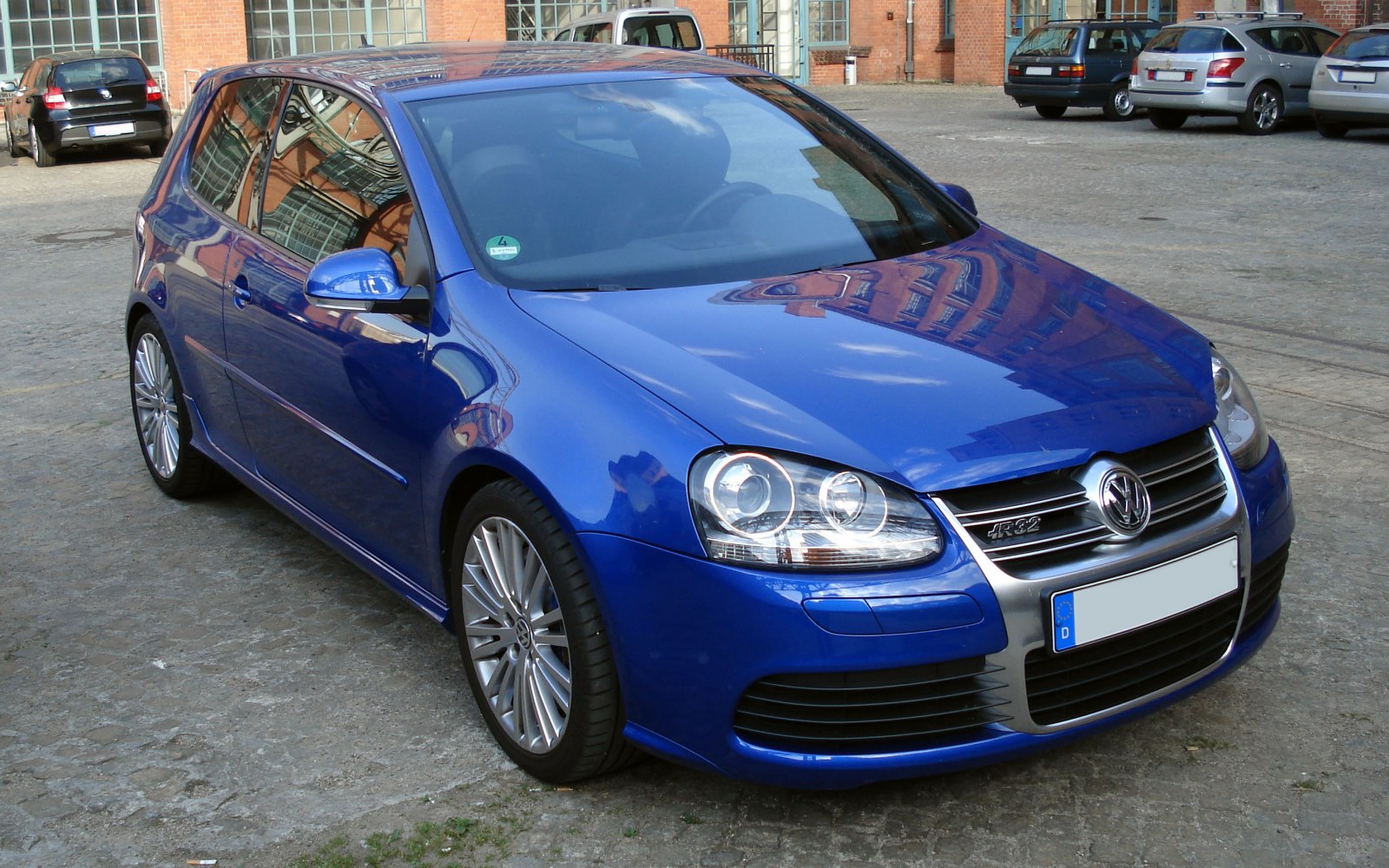 Blue 3-door hatchback with alloy wheels and detailed headlights