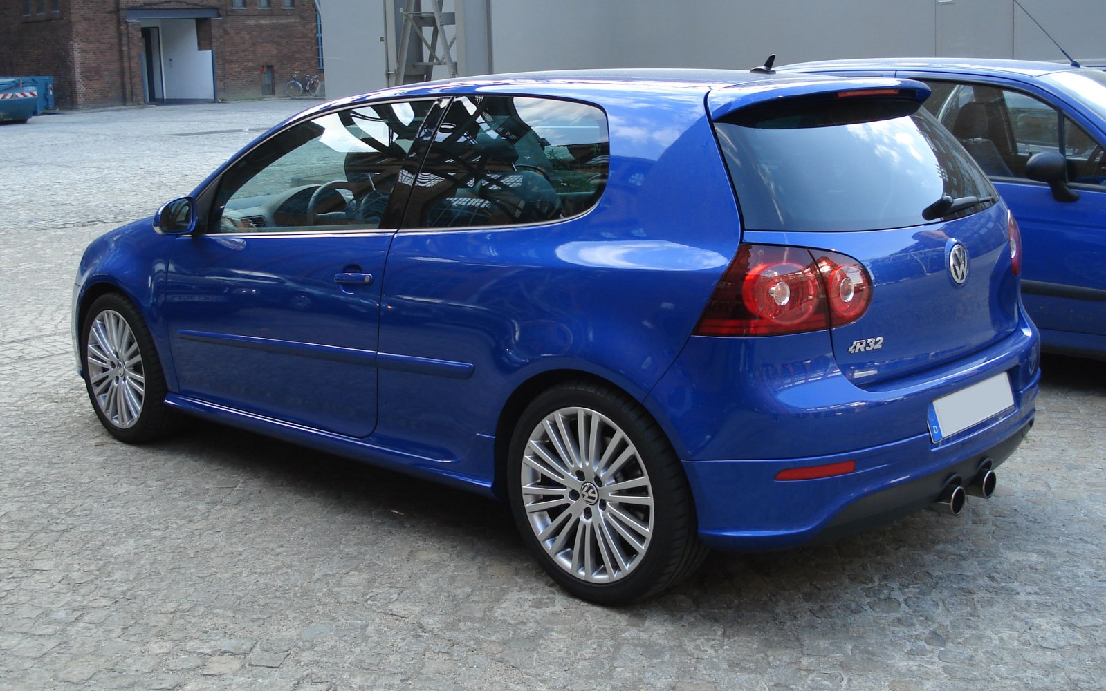 Blue 3-door hatchback with dual exhaust and alloy wheels