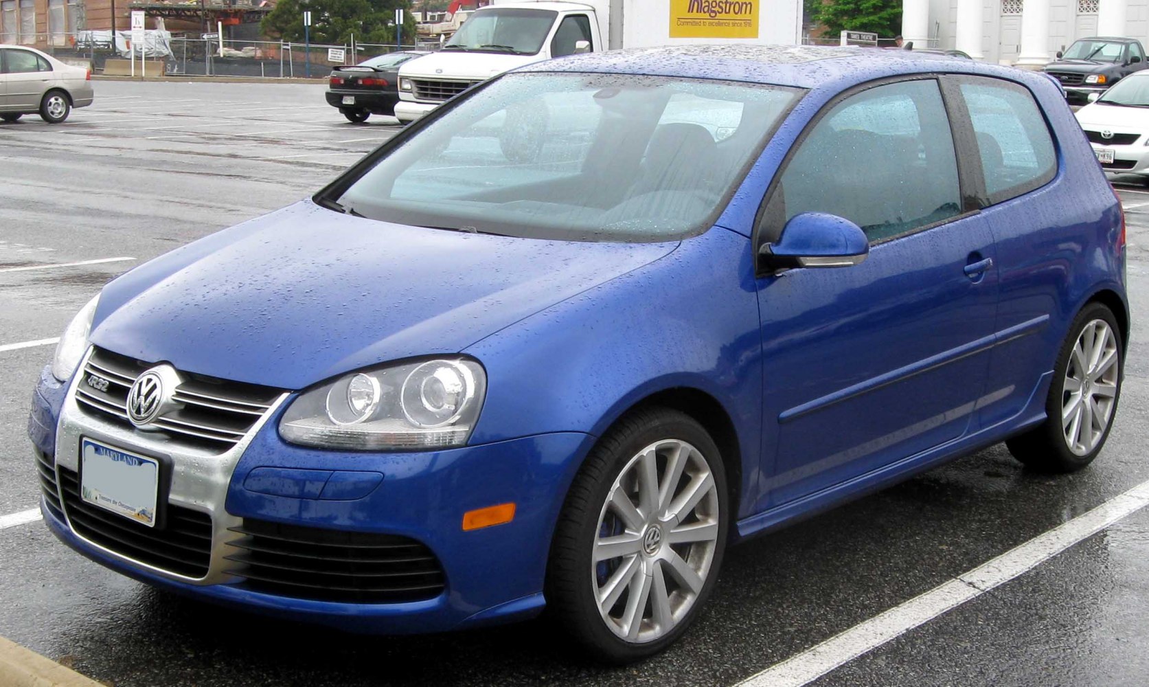 Blue compact 3-door hatchback with alloy wheels and front focus